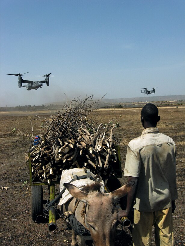 A Malian boy stops to watch incoming Air Force Special Operations Command CV-22 Ospreys carrying Malian and Senegalese troops during an October exercise near Bamako, Mali.  Exercise Flintlock '08 marked the first deployment for the tiltrotor aircraft.  The exercise provides U.S. Special Operations Command forces the opportunity to work with African and European partner nations in the effort to build bonds of trust and confidence.  (U.S. Air Force photo/Capt. Bryan Purtell)