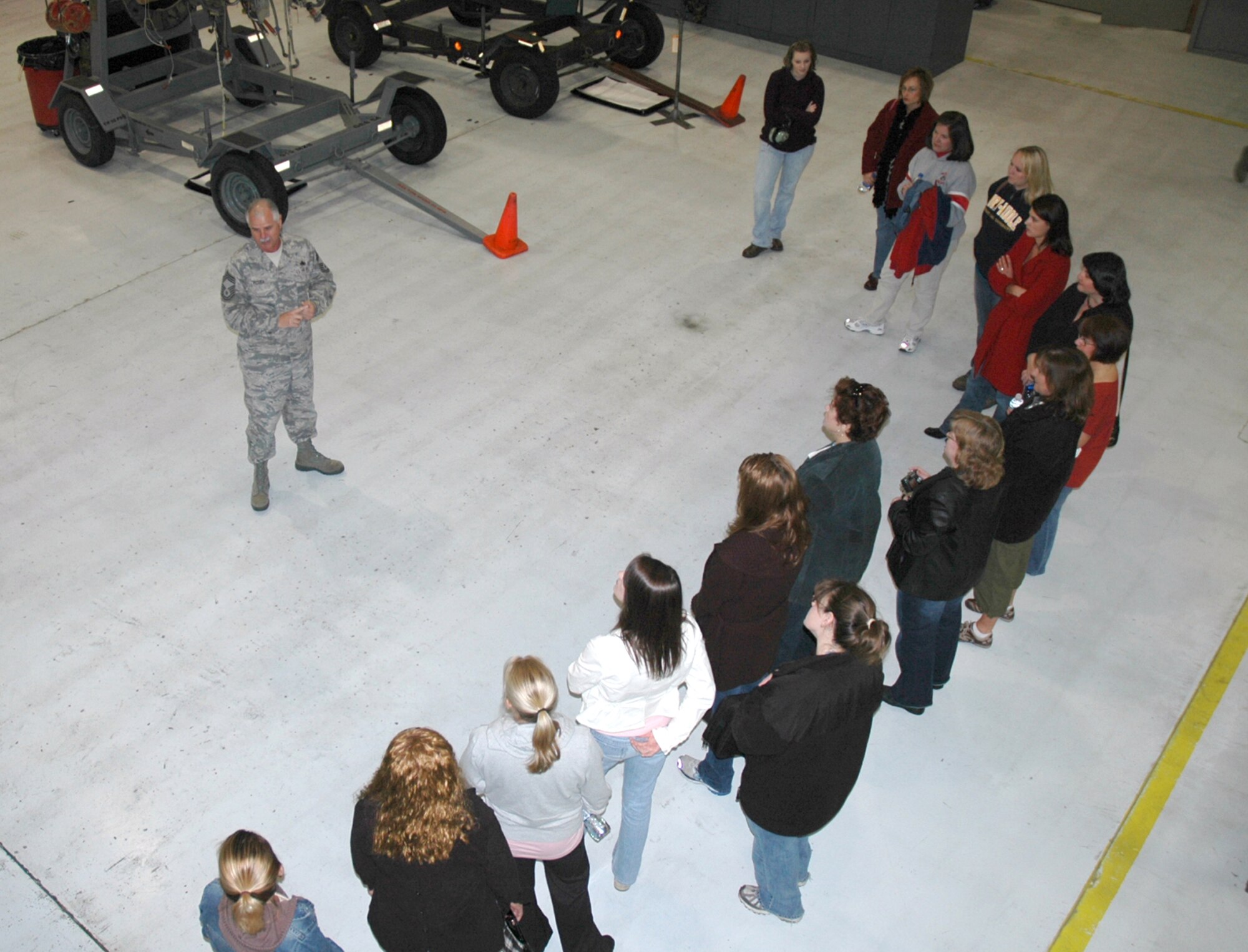 Chief Master Sgt. Kenneth Potter, 919th Maintenance Squadron flight chief, took spouses on a tour of the engine shop at Duke Field. (U.S. Air Force Photo/Senior Airman Jon McCallum)