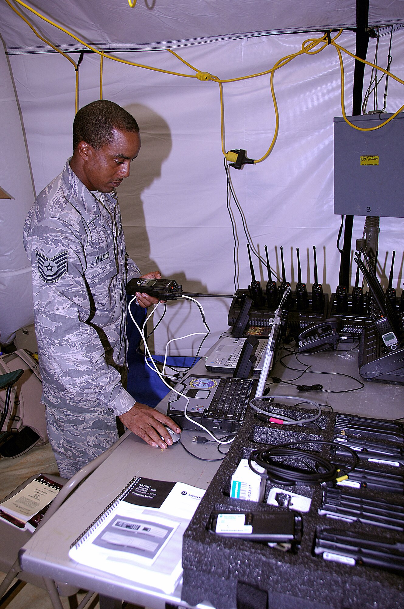 Tech. Sgt. Jason Wilson demonstrates the steps taken to program land mobile radios during the squadron's Dragon Thunder field training exercise Nov. 20 at Andersen Air Force Base, Guam. Sergeant Wilson is the 644th Combat Communications Squadron radio maintenance NCO in charge. (U.S. Air Force photo/Senior Airman Shane Dunaway) 
