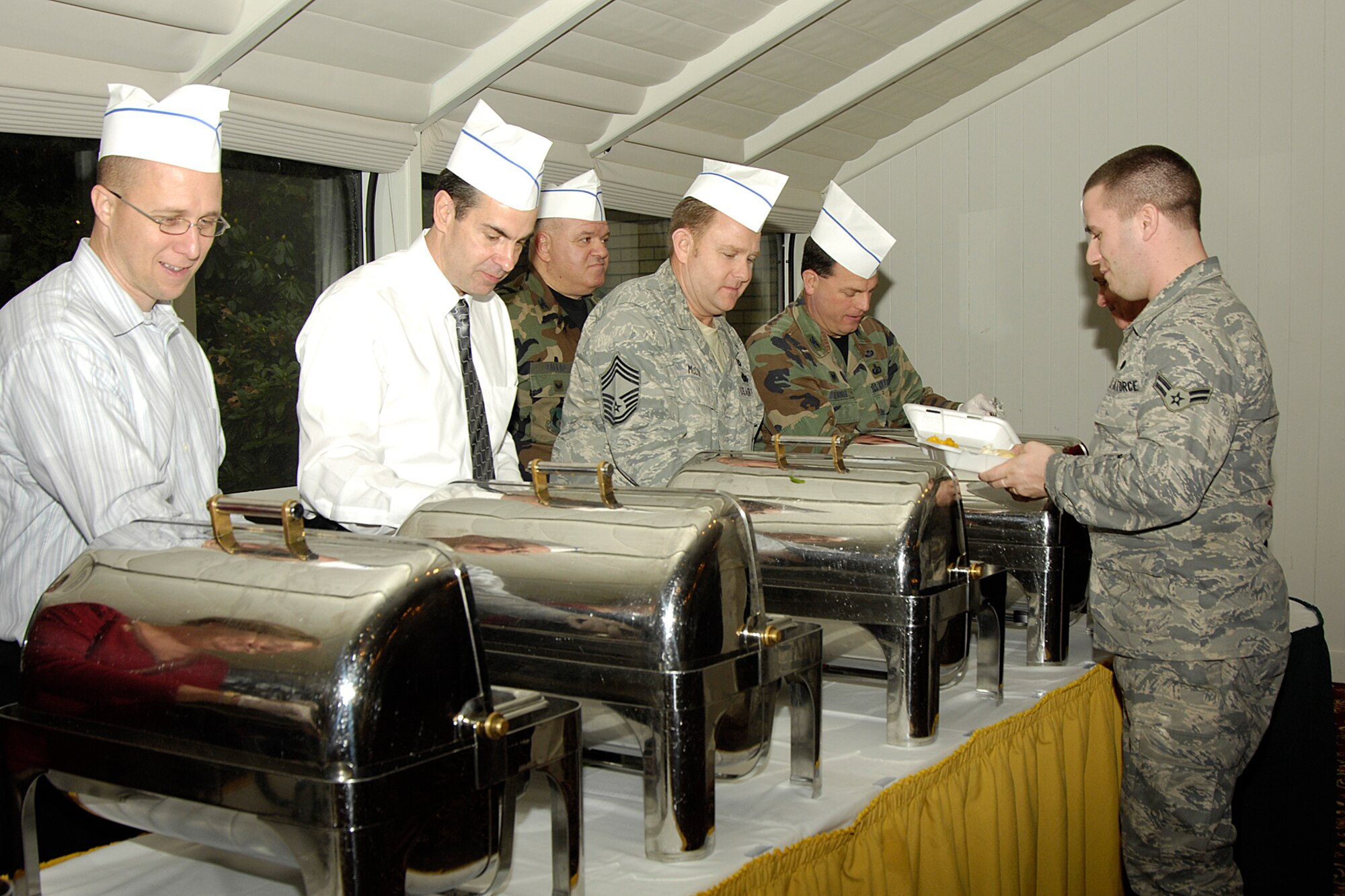 HANSCOM AIR FORCE BASE, Mass. - Hanscom and Electronic Systems Center leaders serve up a holiday-style feast for junior members of the enlisted force during the First Sergeant's Council and Operation Concern Holiday Luncheon at the Minuteman Club Nov. 25.  (U.S. Air Force photo by Linda LaBonte Britt)