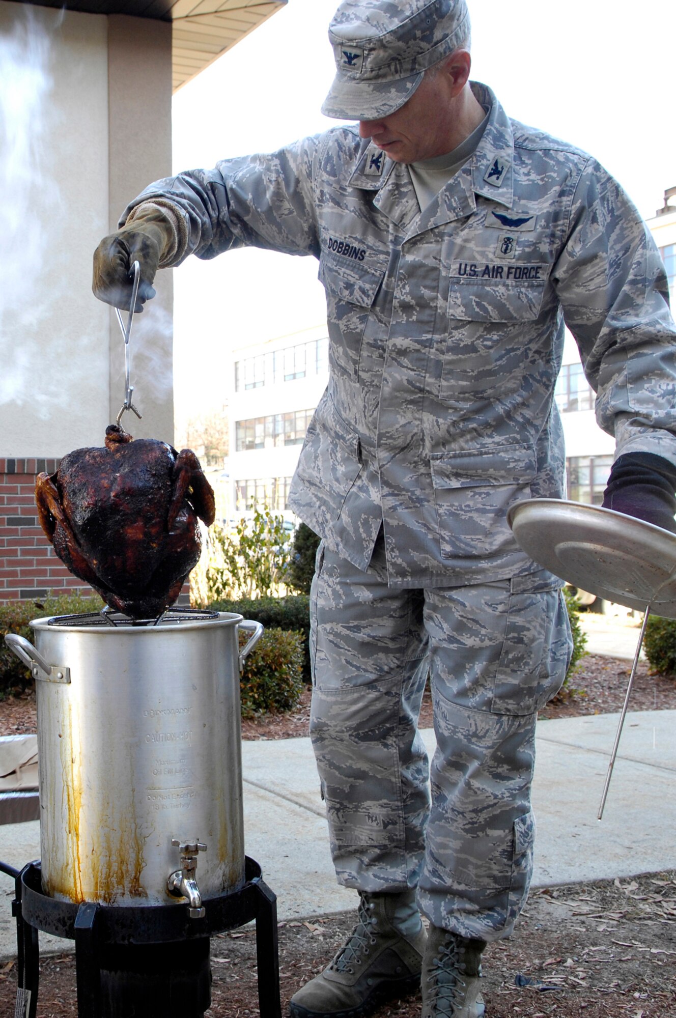Col. Randy Dobbins, 66th Medical Group commander, checks on a turkey he is frying to serve at the 66 ABW Wingman Day lunch.  (U.S. Air Force photo by Mark Wyatt)