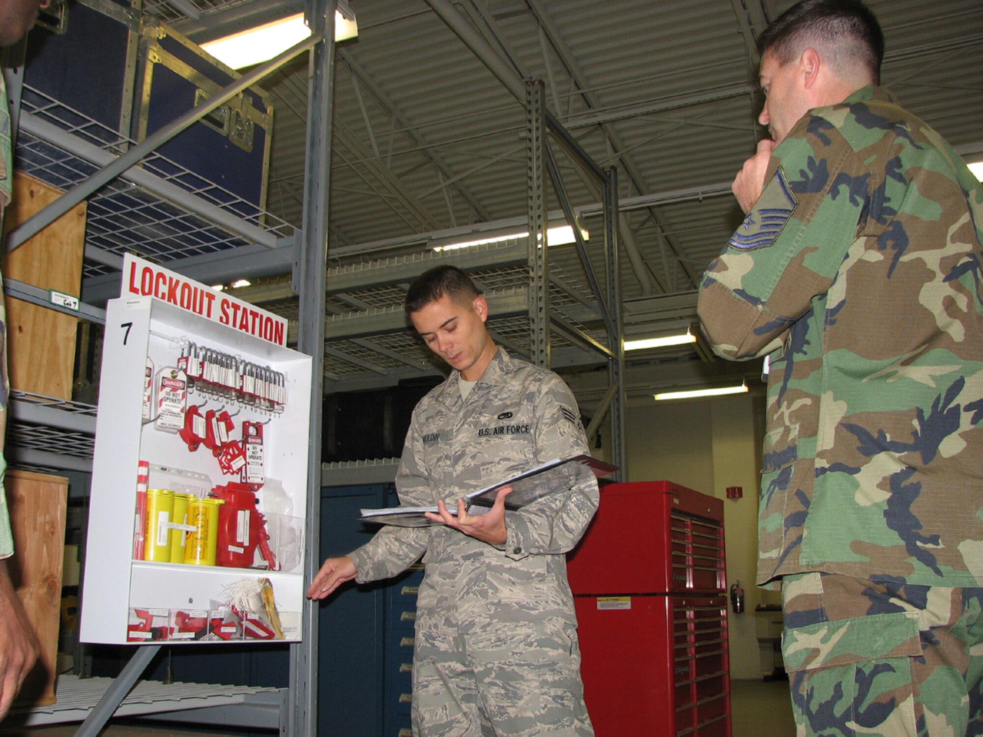 Senior Airman Derek Gauldin, a maintenance Airman from the 819th Global Support Squadron, briefs an AMC IG inspector on the  "Lock-Out, Tag-Out" program during the 621st Contingency Response Wing's unit complicance inspection, Nov. 18-24. Airman Gauldin received recognition from the IG team as a UCI exceptional performer. (U.S. Air Force photo/1Lt Dustin Doyle)