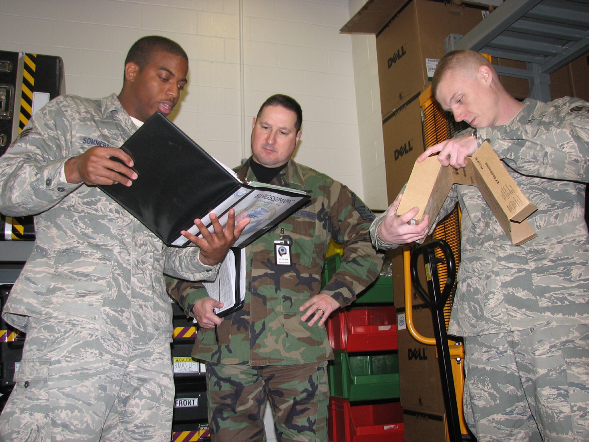 Senior Airmen Kristopher Sommersville and Shawn Knickerbocker, maintenance Airmen from the 819th Global Support Squadron, explain their program to an AMC IG inspector during the 621st Contingency Response Wing unit compliance inspection, Nov. 18-24. The wing earned an overall grade of "Satisfactory" in the first-ever UCI administered by the AMC IG to a CRW. (U.S. Air Force photo/1Lt Dustin Doyle)