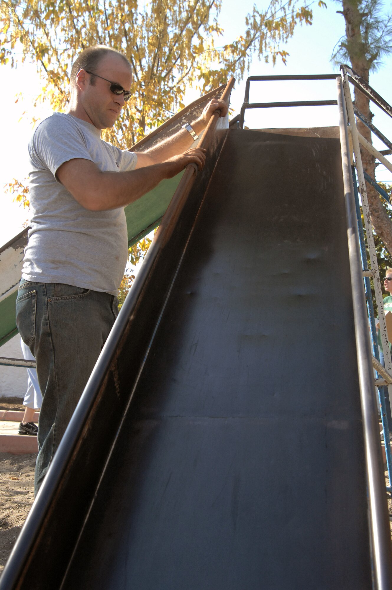 Staff Sgt. Christopher Self sands rust off a slide at an Incirlik Village park Nov 15 at Incirlik Air Base, Turkey. Sergeant Self was among the estimated 75 volunteers present who helped the Incirlik Air Base Chapel staff renovate the park. Sergeant Self is assigned to the 39th Logistics Readiness Squadron. (U.S. Air Force photo/Senior Airman Benjamin Wilson) 

