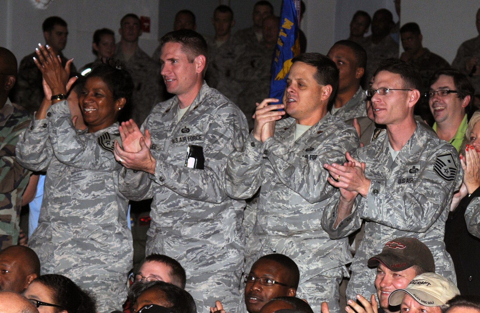 Chief Master Sgt. Trae King, 12th Mission Support Squadron Military Personnel Flight, Maj. Gregory Beaulieu, 12th MSS MPF commander, Maj. Corey Brunson, 12th MSS commander, and Master Sgt. Chad Winkelman, 12th MSS first sergeant, cheer on other mission support units as scores are announced at the 12th Flying Training Wing 2008 Operational Readiness Inspection outbriefing at the base theater Tuesday. The wing earned an "Excellent" rating from ORI inspectors. (U.S. Air Force photo by Don Lindsey)