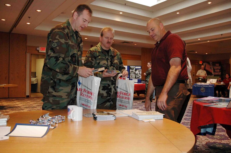 Staff Sgt. Cory Upmeyer(left) and Master Sgt. Louis Herbes, 934th Mission Support Flight, obtain informationabout post deployment transition from Allan Jorgensen, state transition assistance advisor, at the Deployment Matters Information Fair Nov. 1 at the Services Club. Representatives from state, federal and local agencies were on hand to offer information and assitance to reservists and their families about the deployment process and integrating back into civilian life afterward. (Air Force photo/Master Sgt. Paul Zadach)