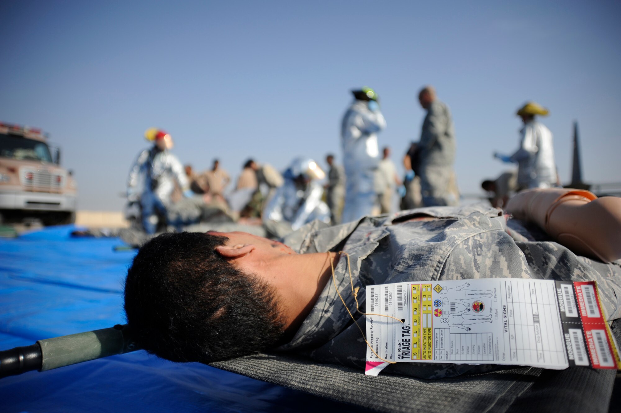 A mock immediate care casualty lays on a stretcher during a major accident response exercise at New Al-Muthana Air Base, Iraq on Nov. 21, 2008. Triage tags help designate the priority of casualties, document the vitals and track the individual until they can be transported to a medical facility. (U.S. Air Force photo/Staff Sgt. Paul Villanueva II)