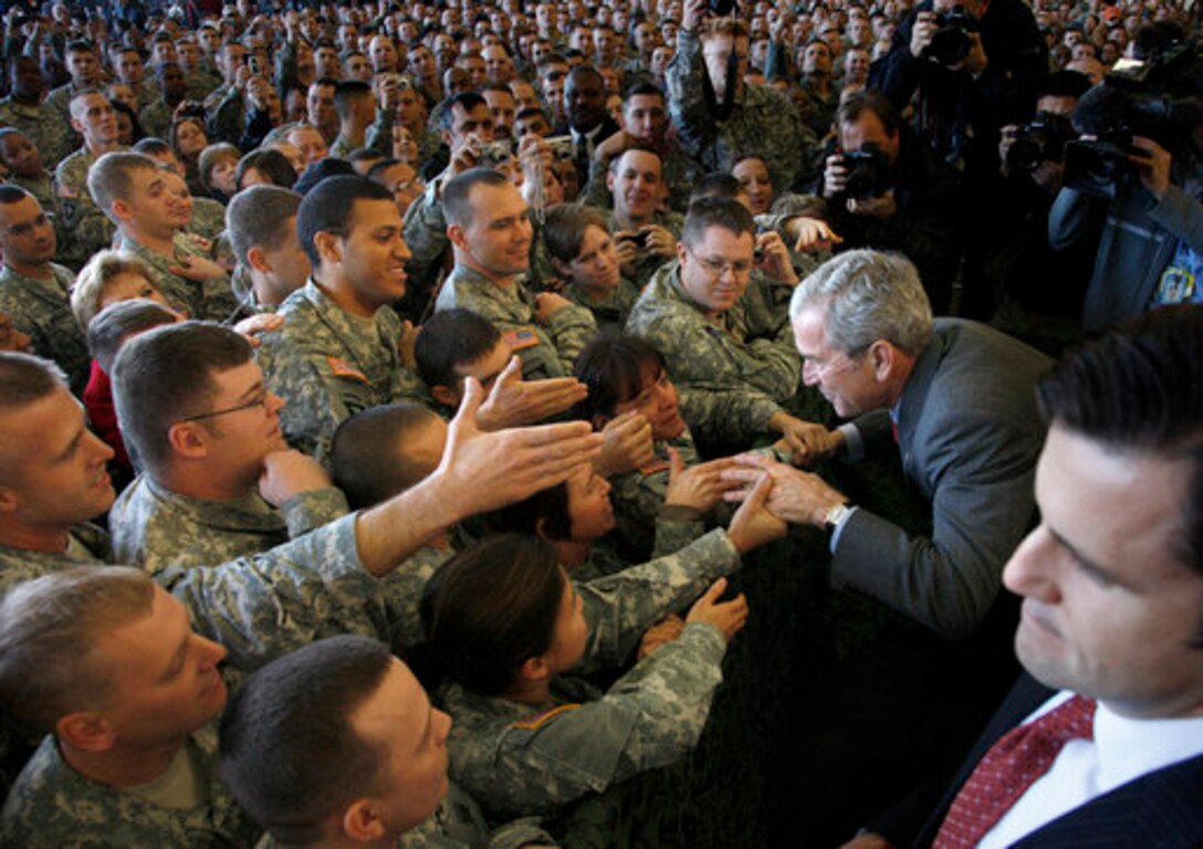 President George W. Bush greets his audience, Nov. 25, 2008, after addressing the troops at Fort Campbell, Ky. "I'm honored to be with the Screaming Eagles of the 101st Airborne; the Night Stalkers of the 160th; the Green Berets of the 5th Special Forces Group, all members of the Fort Campbell community," said Bush. "You are part of the finest military in the world. I have one word for you: Hooah!" 