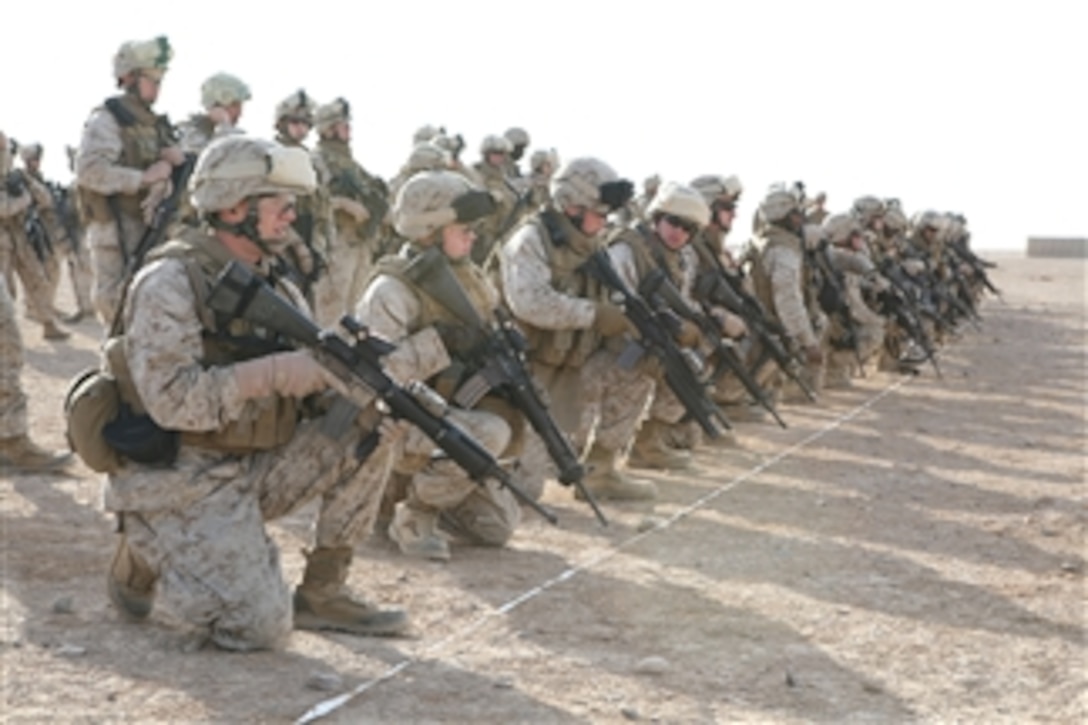 U.S. Marines with Headquarters and Service Company, 3rd Battalion, 8th Marine Regiment kneel at the firing line during live-fire training on the battle site zero range at Camp Bastion, Afghanistan, on Nov. 22, 2008.  The Marines are required to complete the training as part of their reception, staging, onward movement and integration training.  