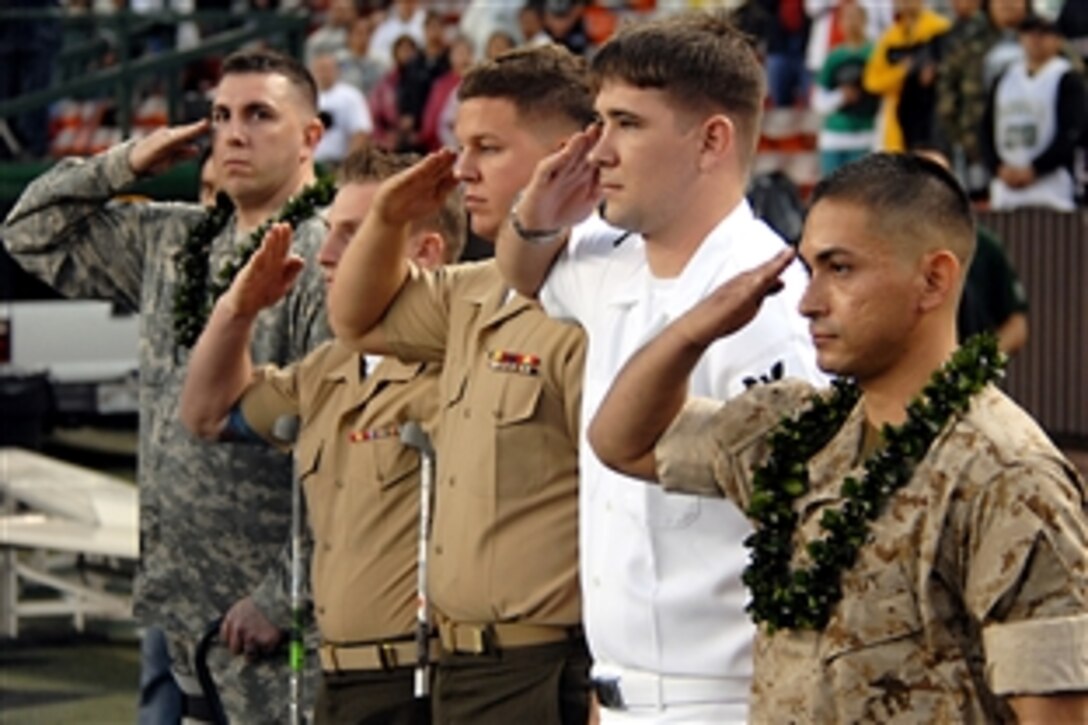 Hawaii-based servicemembers salute the colors during the singing of the National Anthem at Aloha Stadium in Honolulu, Hawaii, Nov. 22, 2008. The local community honored the five wounded warriors during pre-game and halftime ceremonies at the University of Hawaii and University of Idaho college football game.