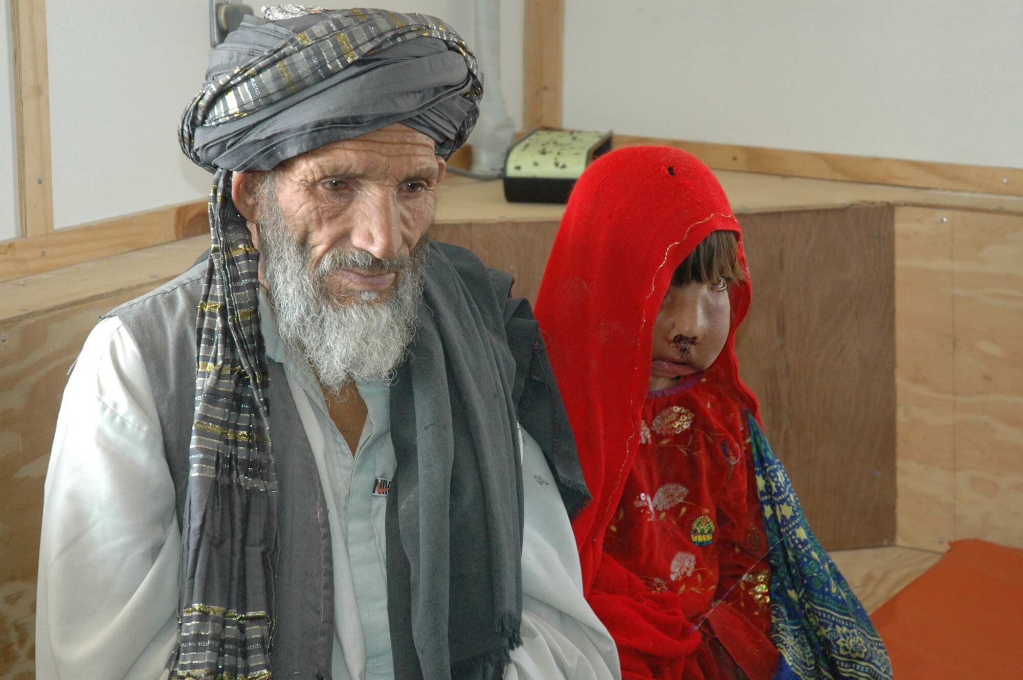 Nov. 5, 9-year-old Toor Pekai,  and her grandfather Malik Khan, rest after a trip from Kandahar Air Field. A team of surgeons at KAF worked six hours to remove a large tumor from Toor Pekai’s face. The tumor had impacted her ability to speak and eat.