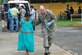 LAS TABLAS, PANAMA-- Master Sgt. James Eidson, a Joint Task Force-Bravo emergency medical technician, escorts a flood victim to a UH-60 Black Hawk helicopter Wednesday. The woman was unable to get to a hospital because the roads were flooded. The JTF-Bravo helicopter transported the woman and five other patients from a remote airfield to an airport where an ambulance met the patients and transported them to a local hospital. (U.S. Air Force photo by 1st Lt. Candace Park)