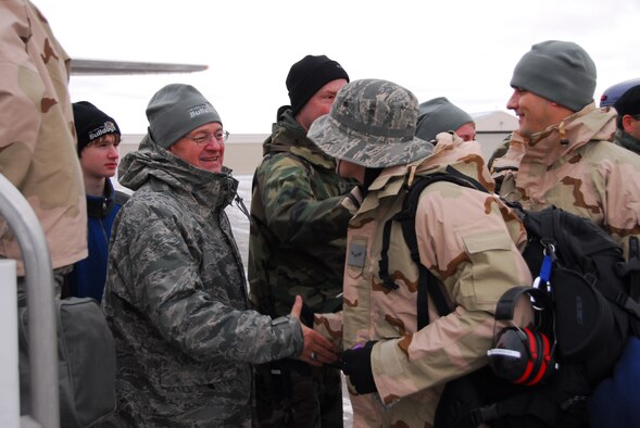 U.S. Air Force Col. Mark Johnson, Wing Commander, (left) shakes hands with guardsmen as approximately 125 members of the 148th Fighter Wing, Duluth Minn. load an aircraft and deploy to Joint Base Balad, Iraq on November 27, 2008 as a part of its Air Expeditionary Force (AEF) deployment. (U.S. Air Force photo by TSgt Jason W. Rolfe) (Released)