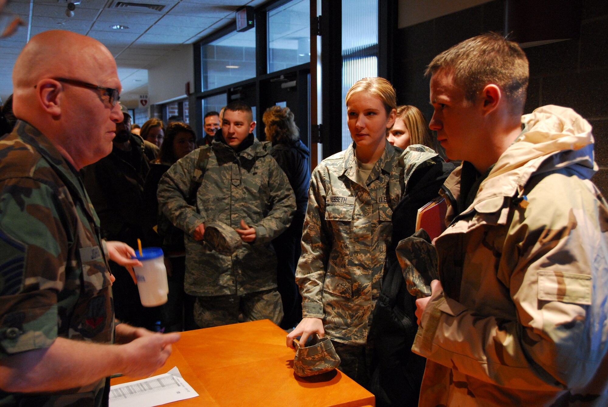 U.S. Air Force Master Sgt. Keith Johnson (left) checks guardsmen into the outprocessing area as approximately 125 members of the 148th Fighter Wing, Duluth Minn. deploy to Joint Base Balad, Iraq on November 27, 2008 as a part of its Air Expeditionary Force (AEF) deployment. (U.S. Air Force photo by TSgt Jason W. Rolfe) (Released)