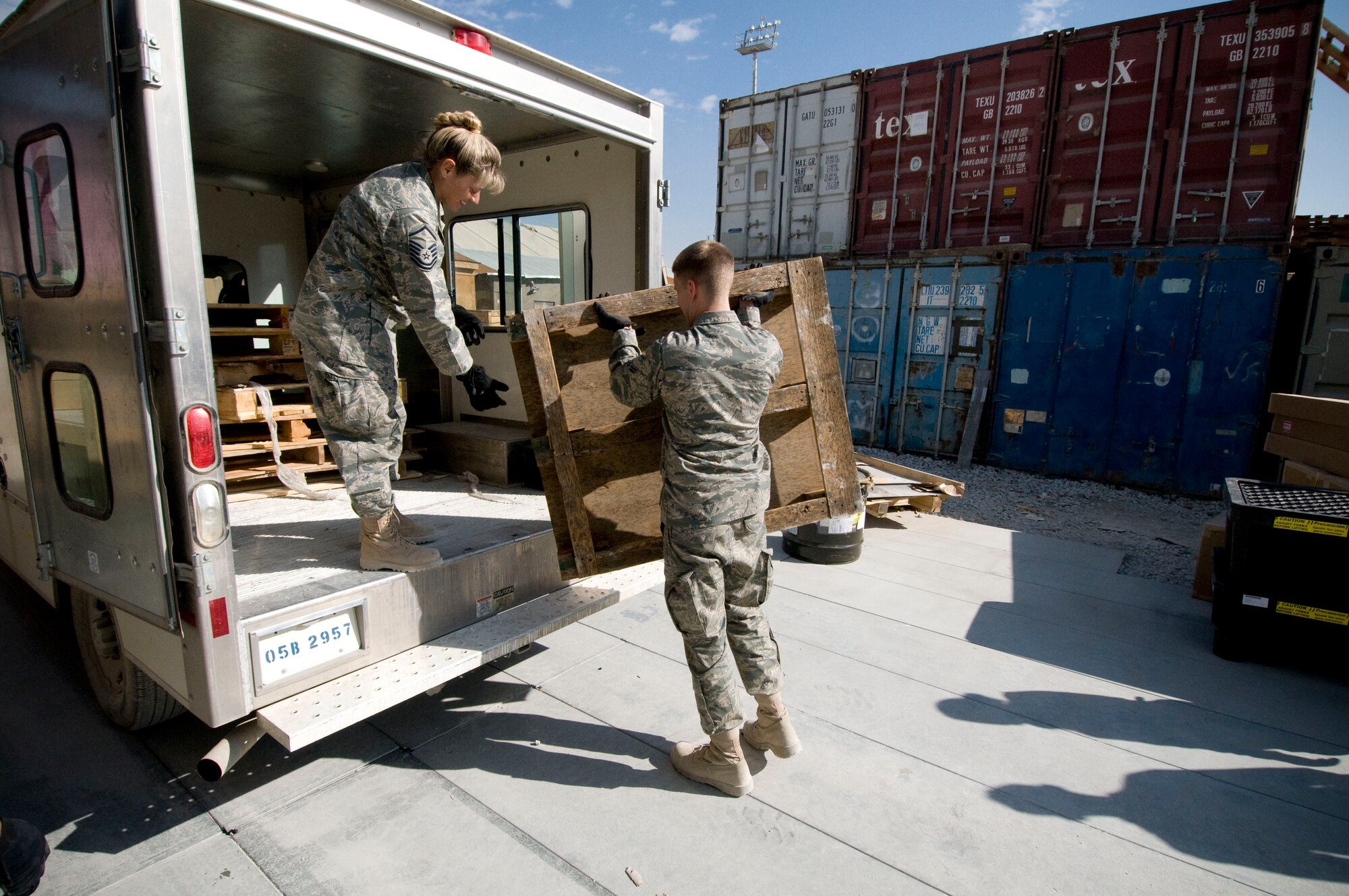 Master Sgt. Kristina Mullins and Airman 1st Class Travis Alexander, 455th Expeditionary Logistics Readiness Squadron, load old pallets into a truck on Thanksgiving, Nov. 27, at Bagram Air Field, Afghanistan. Both express gratitude to their families while deployed and Sergeant Mullins gives additional thanks to her Airmen, who she couldn't do her job without. Sergeant Mullins is from Charleston S.C., and Airman Alexander is from Houston, Texas. (U.S. Air Force photo by Staff Sgt. Samuel Morse)(Released)