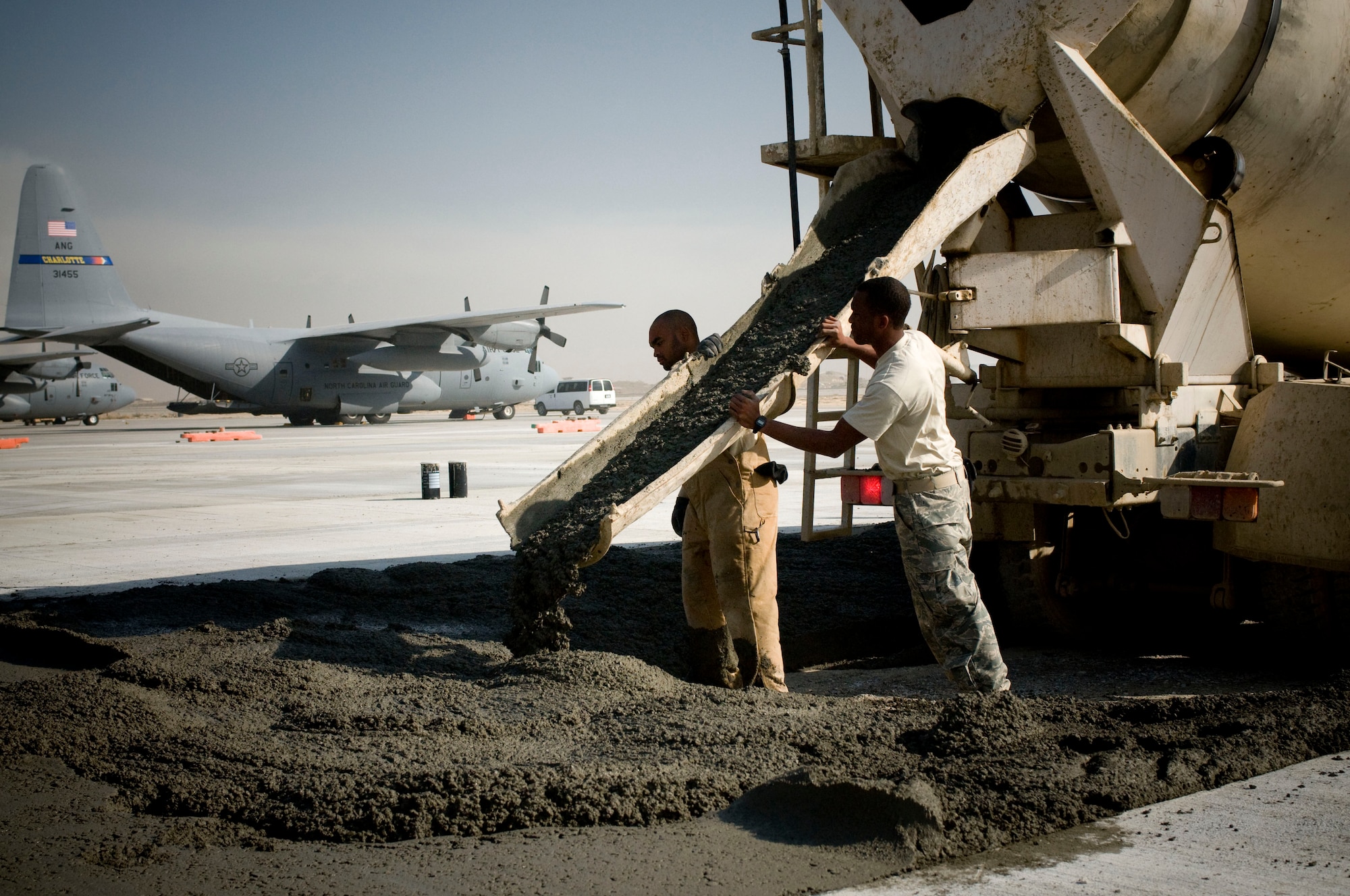 Airmen deployed with the 455th Expeditionary Civil Engineer Squadron pour concrete on Thanksgiving, Nov. 27, at Bagram Air Field, Afghanistan. The occurrence of the national holiday does not deter these Airmen from performing their jobs. (U.S. Air Force photo by Staff Sgt. Samuel Morse)(Released)