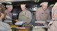 SOUTHWEST ASIA -- (Left to right) The 380th Air Expeditionary Wing Commander Brig. Gen. HD Polumbo, Jr., serves Thanksgiving Day vittles to base members with Lt. Col. Michael Shea, 380th Expeditionary Aircraft Maintenance Squadron commander, and Lt. Gen. Gary North, Air Forces Central and 9th Air Force commander, at Roy's Diner here Nov. 27. The 380th AEW is just one stop on General North's itinerary visiting deployed Airmen in the Area of Responsibility for the holiday. The AFCENT commander said Roy's is always one of his favorite stops in the AOR as the tented dining facility is reminscent of a "mom-and-pop restaurant back home in the states." This is the last Thanksgiving meal to be served at Roy's, as it is scheduled to be closed in the near future. The Containerized Deployment Kitchen is the last of its kind in the AOR. (USAF photo by Tech. Sgt. Denise Johnson) (released)
