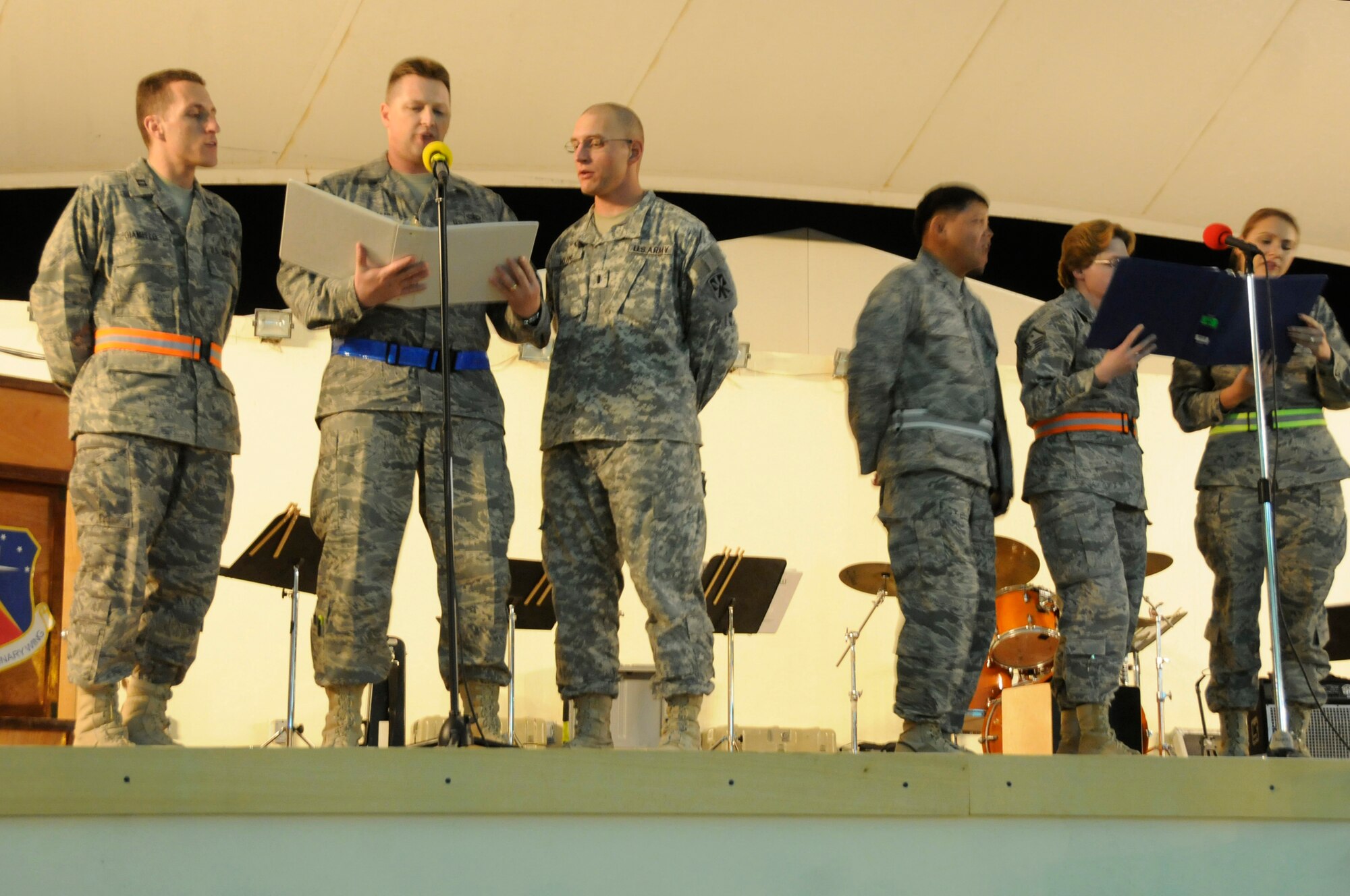 The catholic choir sings the hymn "Table of Plenty" during the Ecumenical Thanksgiving Service Nov. 27, at an undisclosed air base in Southwest Asia. The service was held for all deployed members during the Thanksgiving holiday as a way of reminding everyone all we have to be thankful of while away from family members. All members are deployed in support of Operations Iraqi and Enduring Freedom and Joint Task Force-Horn of Africa. (U.S. Air Force photo by Staff Sgt. Darnell T. Cannady/Released)