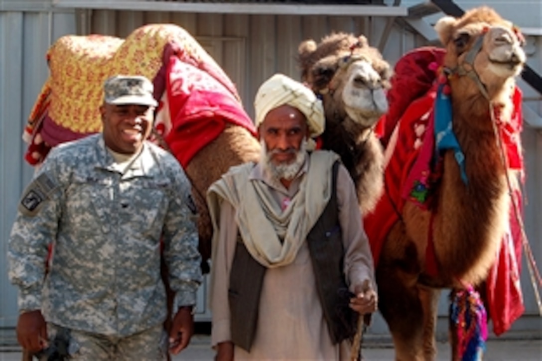 U.S. Army Col. Marion Gale poses with the camels supplied by Morale, Welfare and Recreation in support of Camp Eggers’ winter carnival, Thanksgiving Day, Nov. 27, 2008. Gale is assigned to the Combined Security Transition Command-Afghanistan, Kabul.
