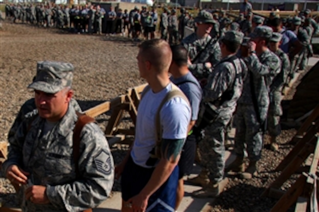 Baghdad soldiers and airmen wait in line outside the Ironhorse Oasis Dining Facility at Camp Liberty, Iraq, for their turn to eat the Thanksgiving Day feast, Nov. 27, 2008.

