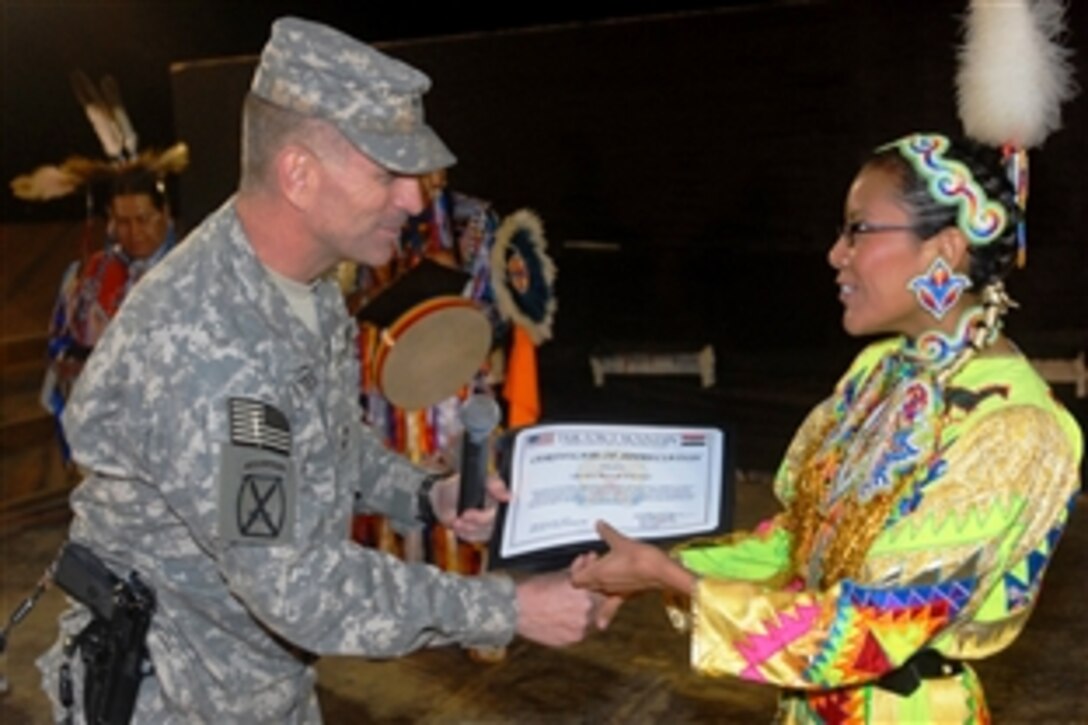 U.S. Army Maj. Gen. Michael Oates presents Urseloria Kanuho, a member of the Kevin Locke Native Dance Ensemble, with a certificate of appreciation following a performance, Nov. 25, 2008, at the Victory Stage, Camp Victory, Iraq.