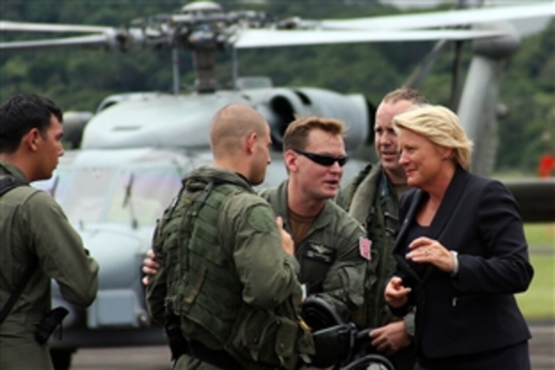 U.S. ambassador to Panama Barbara Stephenson, right, and Lt. Cmdr. Cory Christensen, left, from the U.S. Office of Defense Cooperation at the American embassy in Panama, greet members of the helicopter aircrew from the guided-missile frigate the USS Samuel B. Roberts. The USS Samuel B. Roberts has been diverted from a counter illicit trafficking deployment in the eastern Pacific Ocean to provide aid and disaster relief in Panama after torrential rains caused severe flooding.