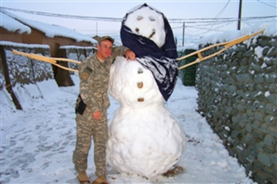 A soldier in Afghanistan celebrates the holidays, by building a snowman, Nov. 26, 2008.