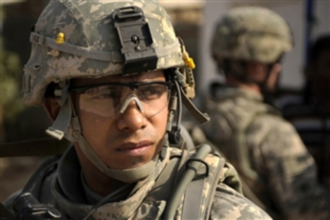 U.S. Army Staff Sgt. Henry Flores III provides security as soldiers patrol Diwaniyah, Iraq, to assess area markets and residents' needs, Nov. 13, 2008. Flores is assigned to the 4th Infantry Division's 2nd Battalion, 8th Infantry Regiment.