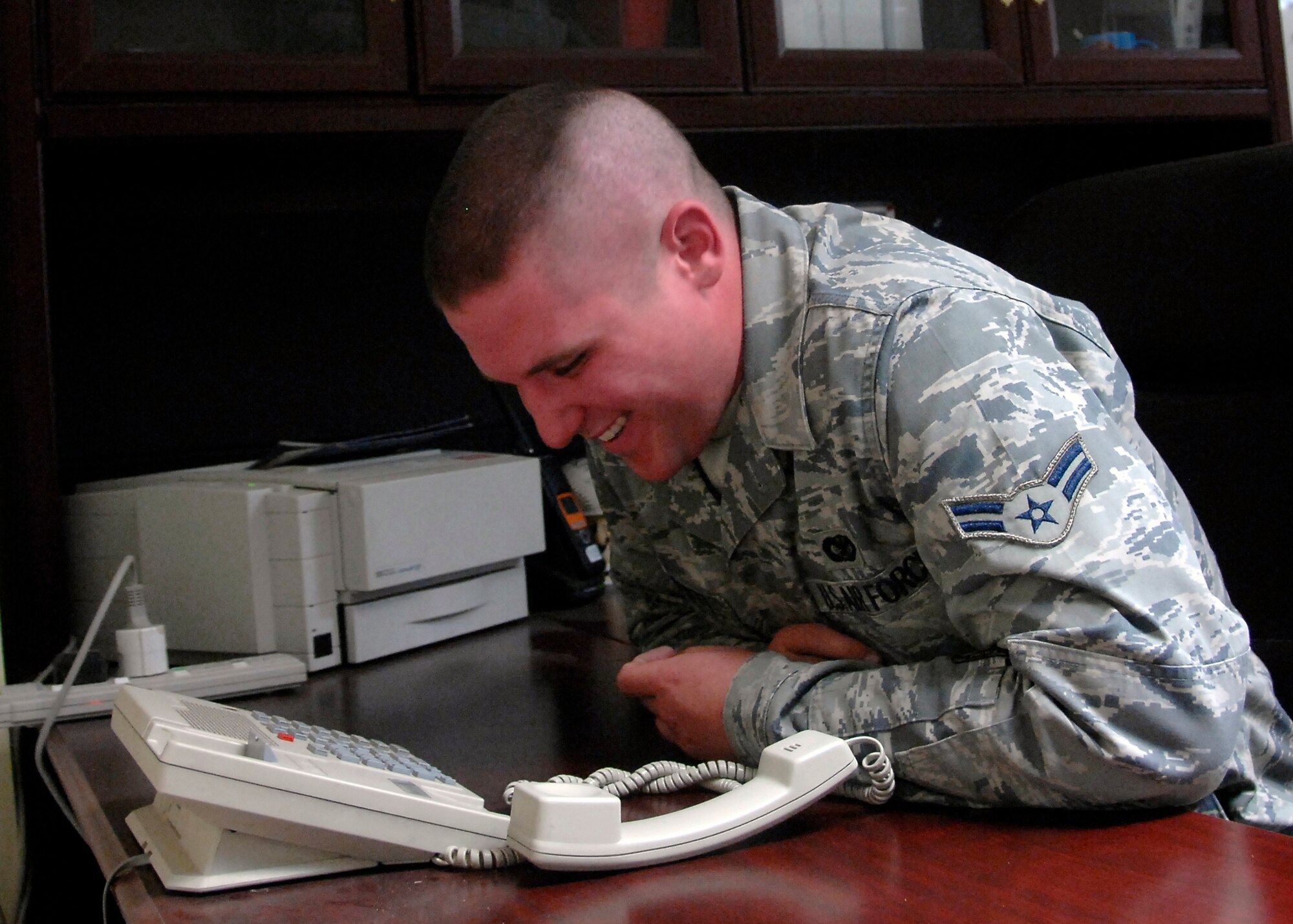 SOUTHWEST ASIA -- Airman 1st Class Thomas Everett, 386th Expeditionary Security Forces Squadron, receives a phone call from President George W. Bush on Nov. 27 at an air base in Southwest Asia. Airman Everett was among 11 servicemembers who received Thanksgiving phone calls from President Bush. During a cargo mission in early August, Airman Everett saved another Airman's life during an in-flight emergency, resulting in a nomination for the Airman's Medal for his efforts. Airman Everett is deployed from Nellis Air Force Base, Nev. (U.S. Air Force photo/Tech. Sgt. Raheem Moore)
