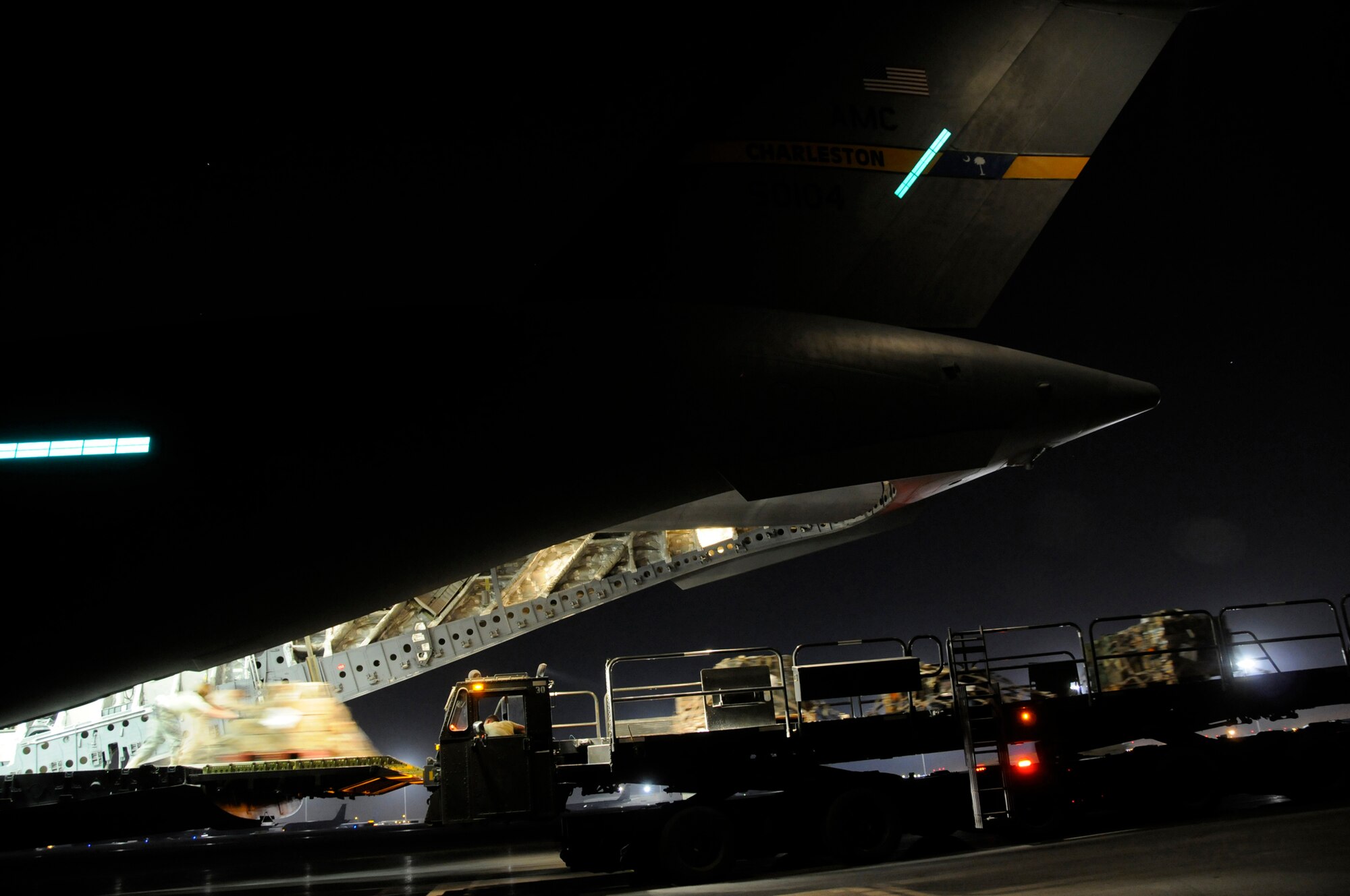 Members unload a pallet from the back of a C-17 onto a loader, Nov. 19, 2008, at an undisclosed air base in Southwest Asia. The C-17 has been delivering cargo to and from different bases in the area of responsibility in support of Operation Iraqi Freedom. (U.S. Air Force photo by Staff Sgt. Darnell T. Cannady/Released)