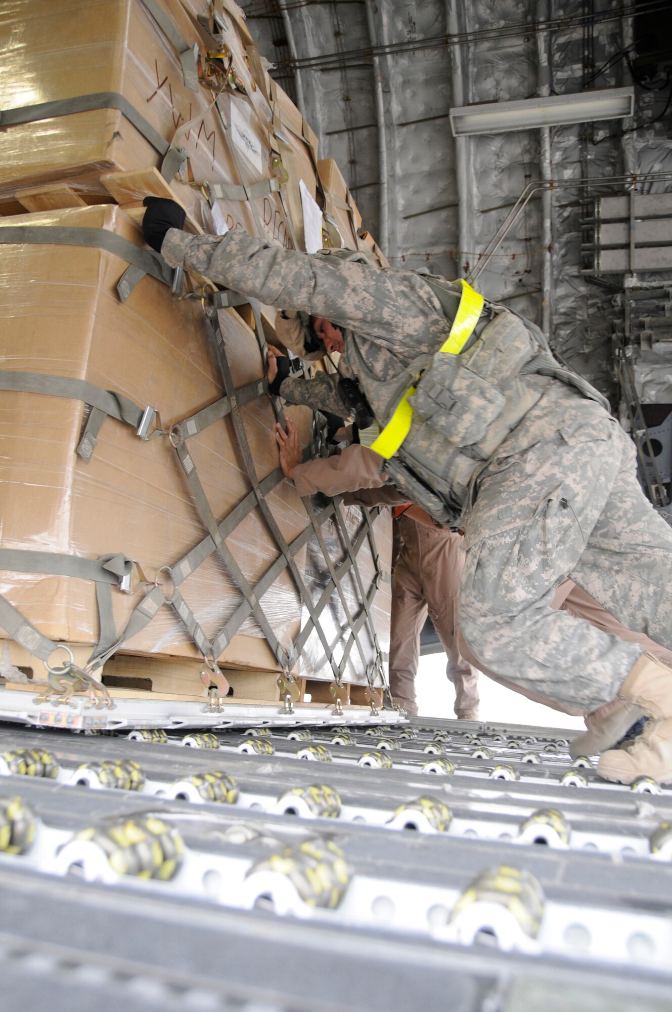 Members load cargo onto the back of a C-17, Nov. 19, 2008, at Balad Air Base, Iraq. The C-17 has been delivering cargo to and from different bases in the area of responsibility in support of Operation Iraqi Freedom. (U.S. Air Force photo by Staff Sgt. Darnell T. Cannady/Released)