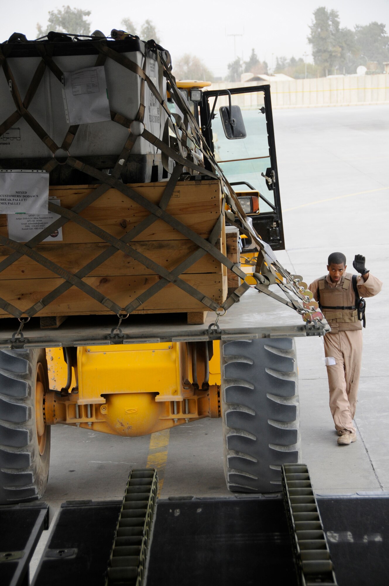 Senior Airman Anthony Johnson, aircraft load master assigned to the 816th Expeditionary Airlift Squadron, directs a forklift to the back of a C-17 so it can load cargo onto the aircraft, Nov. 19, 2008, at Balad Air Base, Iraq. Airman Johnson, a native of Columbus, Ga., is deployed from Charleston Air Force Base, S.C., in support of Operations Iraqi and Enduring Freedom and Joint Task Force-Horn of Africa. (U.S. Air Force photo by Staff Sgt. Darnell T. Cannady/Released)