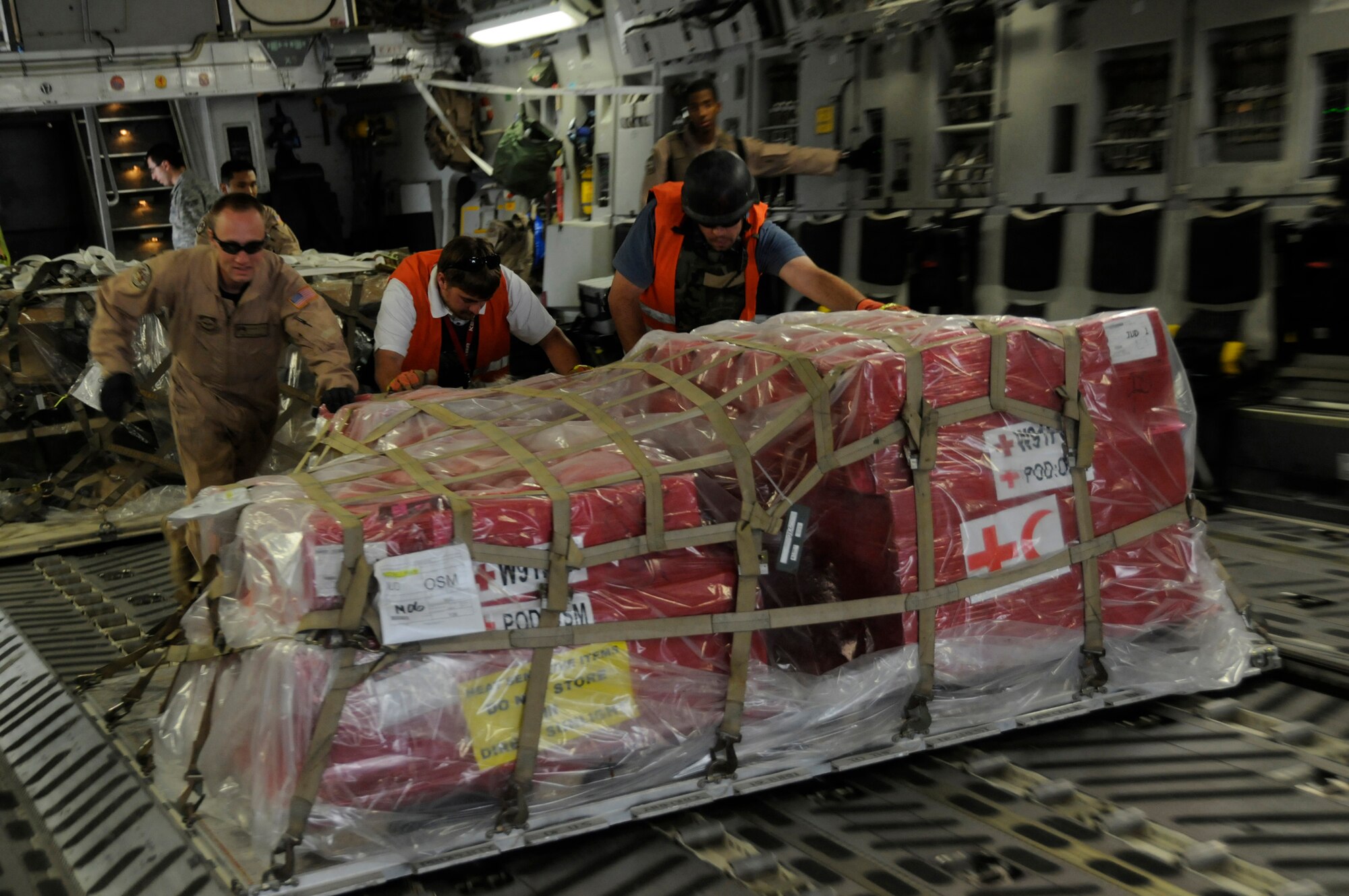 Members unload cargo from the back of a C-17, Nov. 19, 2008, at Mosul Air Base, Iraq. The C-17 has been delivering cargo to and from different bases in the area of responsibility in support of Operation Iraqi Freedom. (U.S. Air Force photo by Staff Sgt. Darnell T. Cannady/Released)