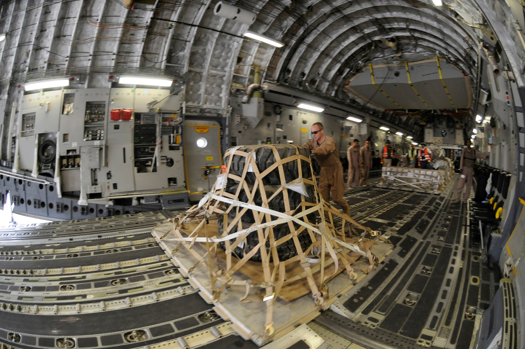 Members unload cargo from the back of a C-17, Nov. 19, 2008, at Mosul Air Base, Iraq. The C-17 has been delivering cargo to and from different bases in the area of responsibility in support of Operation Iraqi Freedom.  (U.S. Air Force photo by Staff Sgt. Darnell T. Cannady/Released)