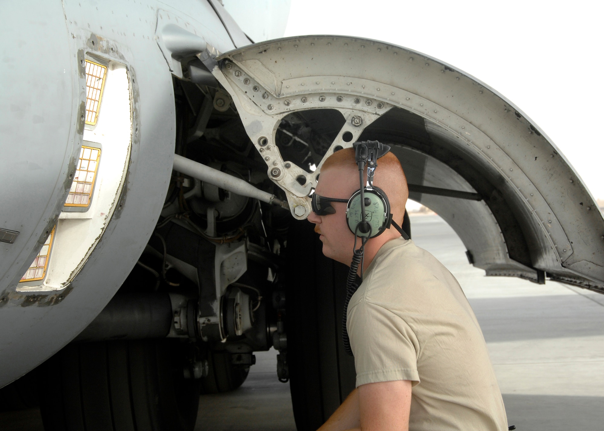 SOUTHWEST ASIA -- Airman 1st Class Michael Depue, 5th Expeditionary Aircraft Maintenance Squadron crew chief, visually checks aircraft flares to make sure they are properly seated on a C-17 Globemaster III aircraft on Nov. 26 at an air base in Southwest Asia. The 5 EAMS performs maintenance on C-5 and C-17 aircraft deployed in support of Operations Iraqi and Enduring Freedom. Airman Depue is deployed from McCord Air Force Base, Wash. (U.S. Air Force photo/Tech. Sgt. Raheem Moore)