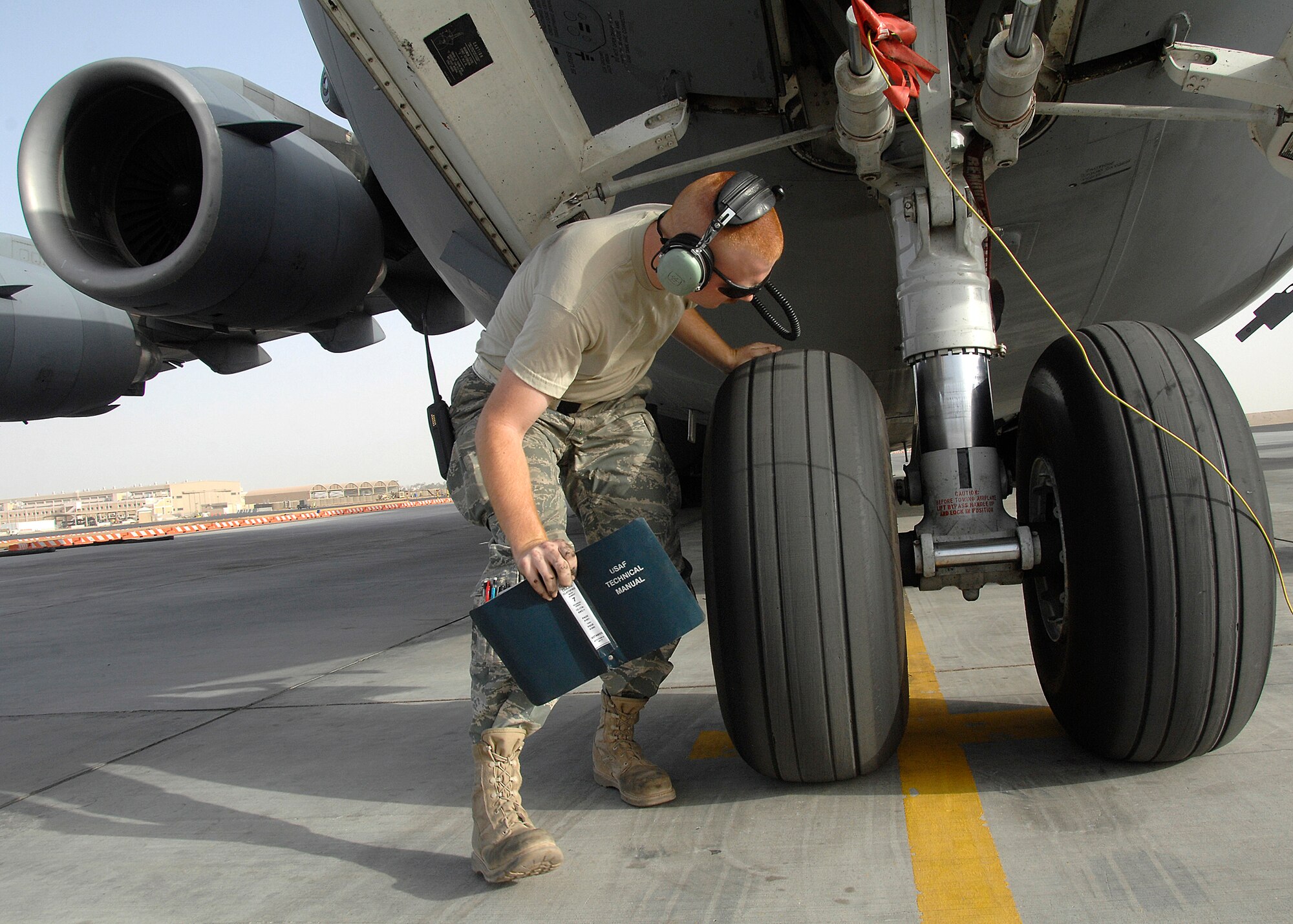 SOUTHWEST ASIA -- Airman 1st Class Michael Depue, 5th Expeditionary Aircraft Maintenance Squadron crew chief, conducts a tire inspection on a C-17 Globemaster III aircraft on Nov. 26 at an air base in Southwest Asia. The 5 EAMS performs maintenance on C-5 Galaxy and C-17 aircraft deployed in support of Operations Iraqi Freedom and Enduring Freedom. Airman Depue is deployed from McCord Air Force Base, Wash. (U.S. Air Force photo/Tech. Sgt. Raheem Moore)