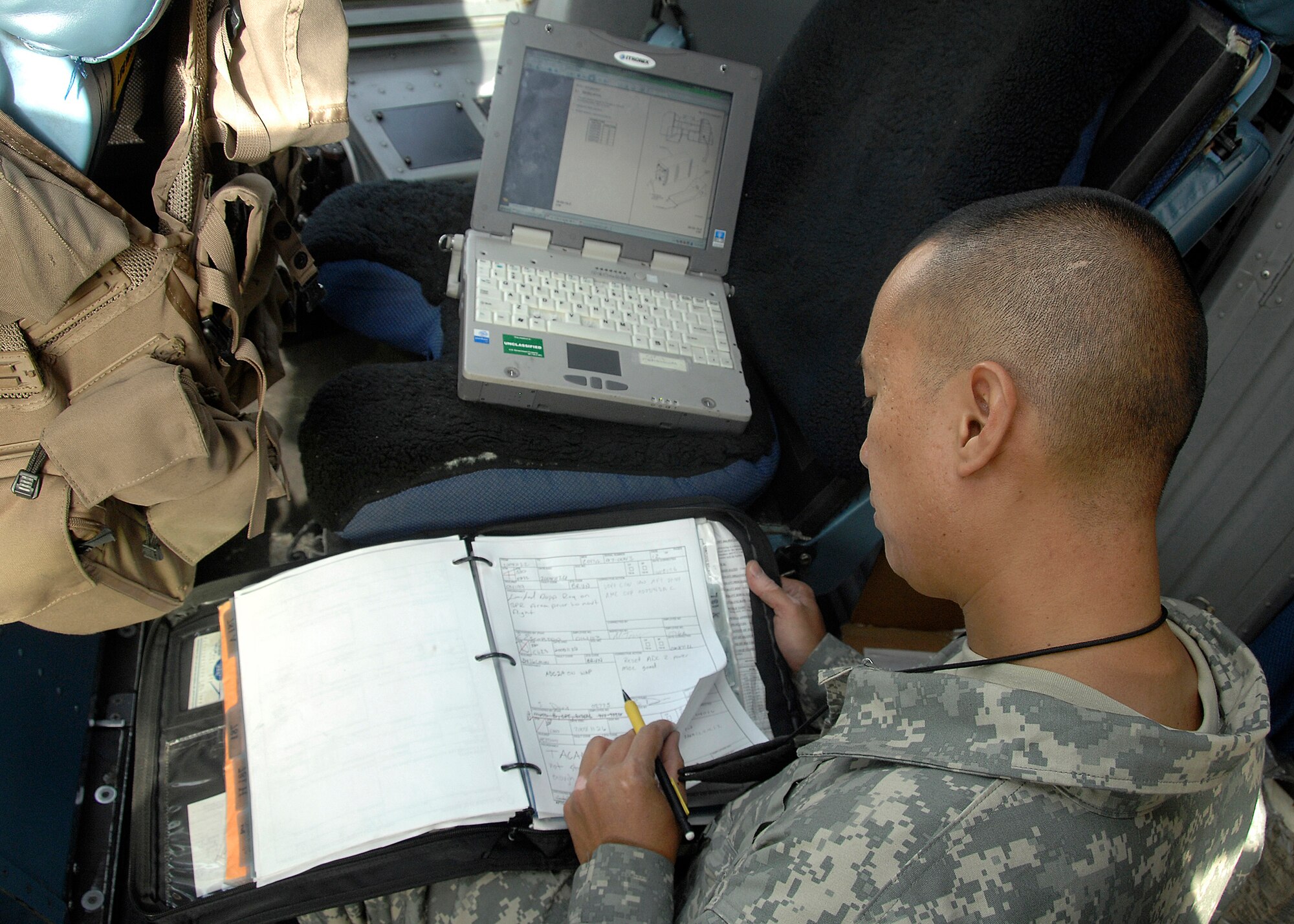 SOUTHWEST ASIA -- Staff Sgt. Nelson Pegarido, 5th Expeditionary Aircraft Maintenance Squadron electro-environmental specialist, checks his technical orders prior to performing an inspection on a C-17 Globemaster III aircraft on Nov. 26 at an air base in Southwest Asia. The 5th EAMS performs maintenance on C-5 Galaxy and C-17 aircraft deployed in support of Operations Iraqi Freedom and Enduring Freedom. Sergeant Pegarido is deployed from McCord Air Force Base, Wash. (U.S. Air Force photo/Tech. Sgt. Raheem Moore)