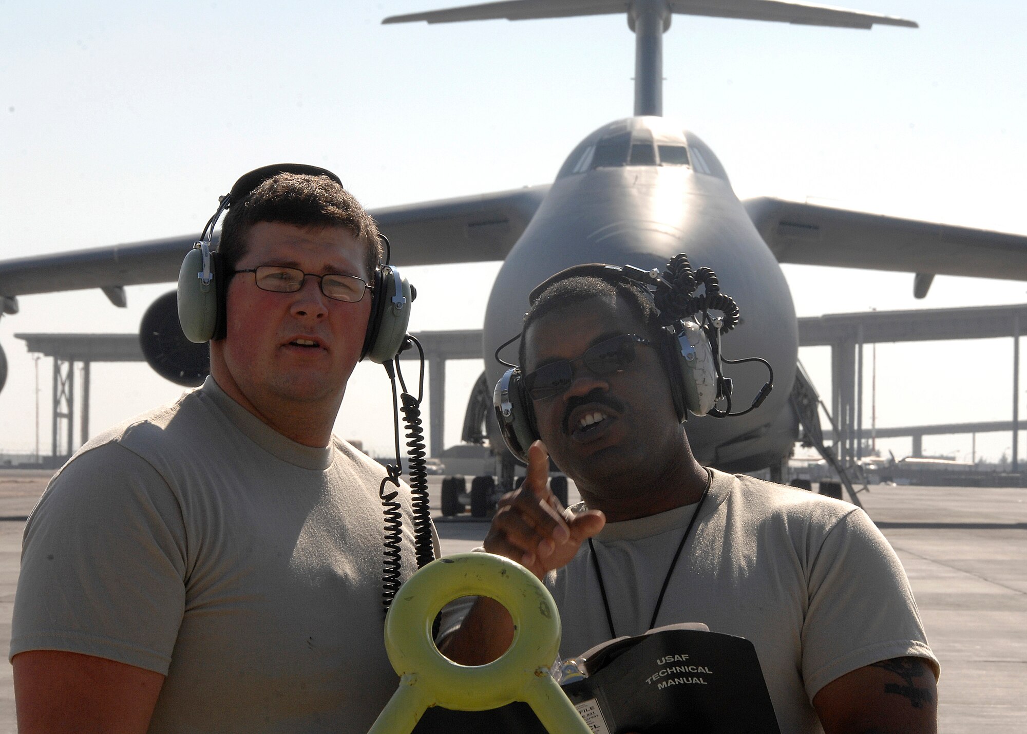 SOUTHWEST ASIA -- Tech. Sgt. Robert Wilson Jr., right, shows Senior Airman Kyle Ward, both 5th Expeditionary Aircraft Maintenance Squadron jet engine mechanics, where they will be conducting their visual inspections of a C-17 Globemaster III on Nov. 25 at an air base in Southwest Asia. The 5th EAMS performs maintenance on C-5 Galaxy and C-17 aircraft deployed in support of Operations Iraqi Freedom and Enduring Freedom. Sergeant Wilson and Airman Ward are both deployed from Dover Air Force Base, Del. (U.S. Air Force photo/Tech. Sgt. Raheem Moore)