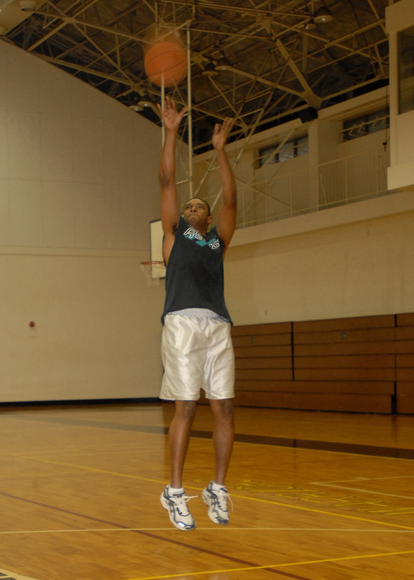 YOKOTA Air Base, Japan- Tech. Sgt. Jerome Stith, 730th Air Mobility Squadron commander's support staff superintendant, shoots hoops Nov. 25. The fitness center offers various sports program year-round. (U.S. Air Force by Airman Sean Martin)