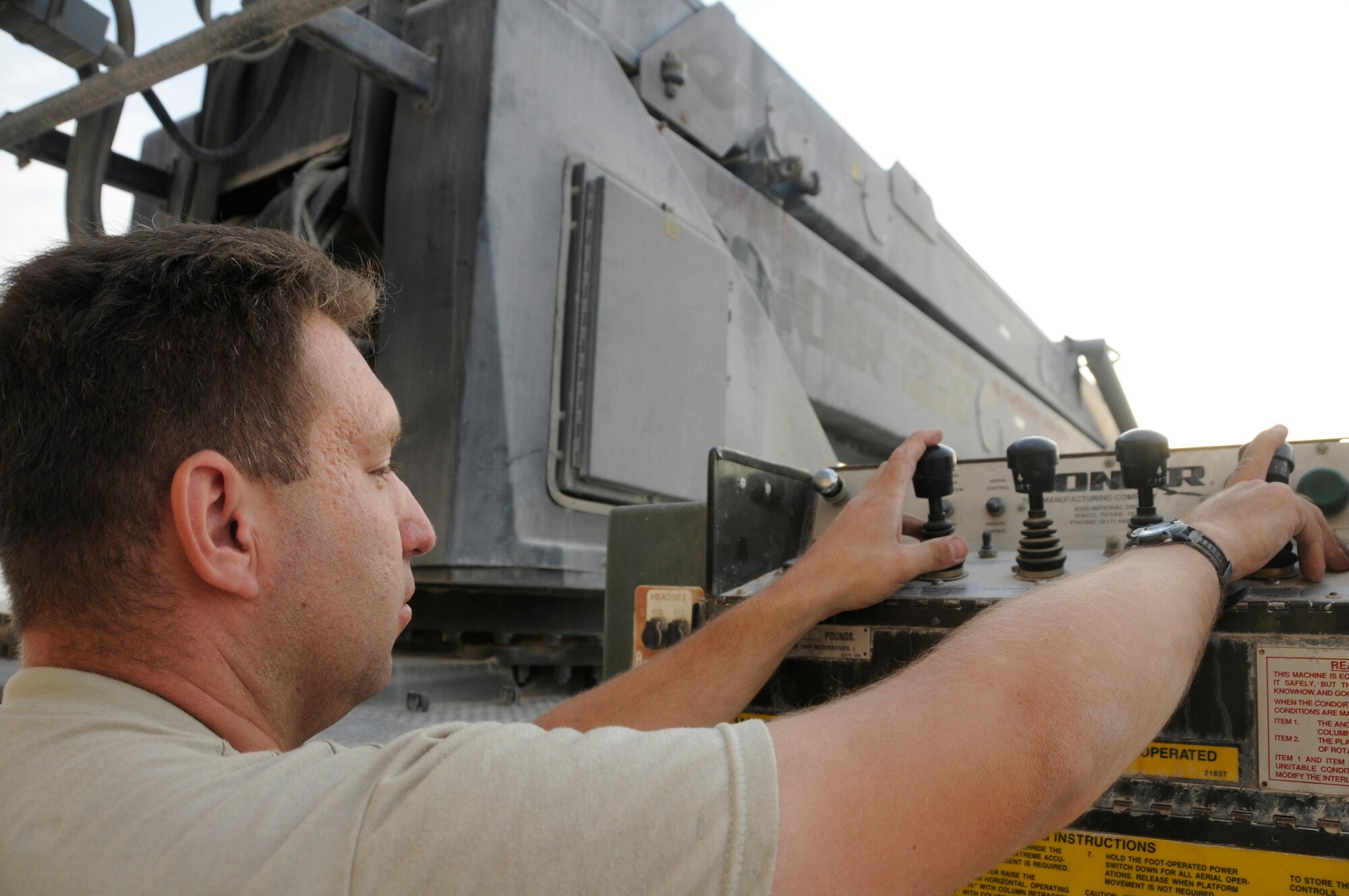 Master Sgt. Michel Senecal, superintendent of Air Terminal Operations assigned to the 8th Expeditionary Air Mobility Squadron, operates the condor to increase his height to finish installing the new flightline security camera Nov. 28, at an undisclosed air base in Southwest Asia. The new security camera will provide a higher view of the activities on the flightline. Sergeant Senecal, a native of Warwick, R.I., is deployed from North Kingston Air National Guard, R.I., in support of Operations Iraqi and Enduring Freedom and Joint Task Force-Horn of Africa. (U.S. Air Force photo by Staff Sgt. Darnell T. Cannady/Released)