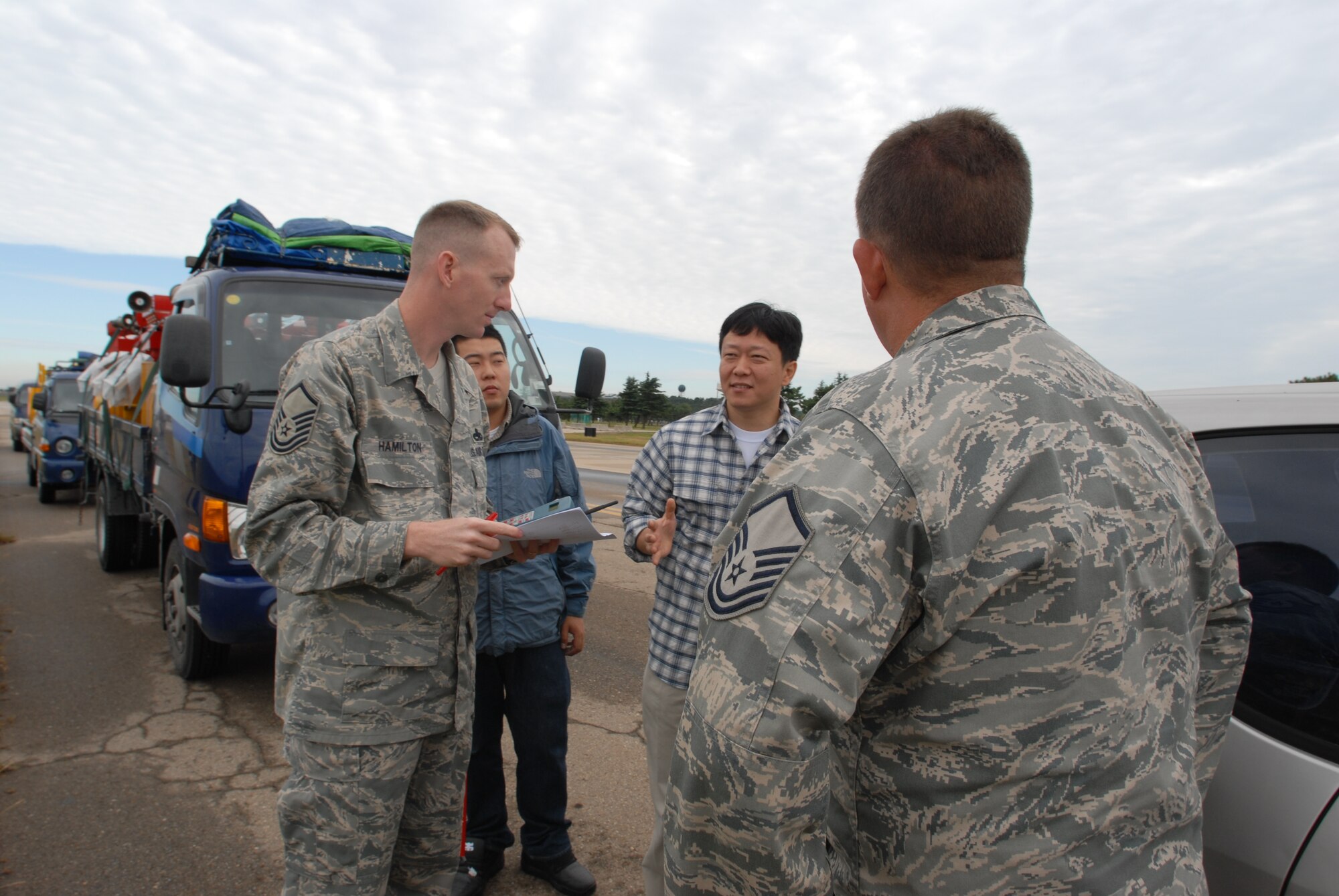 KUSNAN AIR BASE,Republic of Korea -- Master Sgt. Guy Hamilton, 8th Fighter Wing Flight Safety NCOIC, and Master Sgt. Richard Cleveland, 8th Fighter Wing Flight Safety, ask questions about the new bird cannon systems installed here Sep. 29. The bird cannons were installed as part of the Bird Wildlife Aircraft Strike Hazard program, that aims to keep flight line and a variety of aircraft safe from bird hazards.(U.S. Air Force photo by Senior Airman Angela Ruiz) 