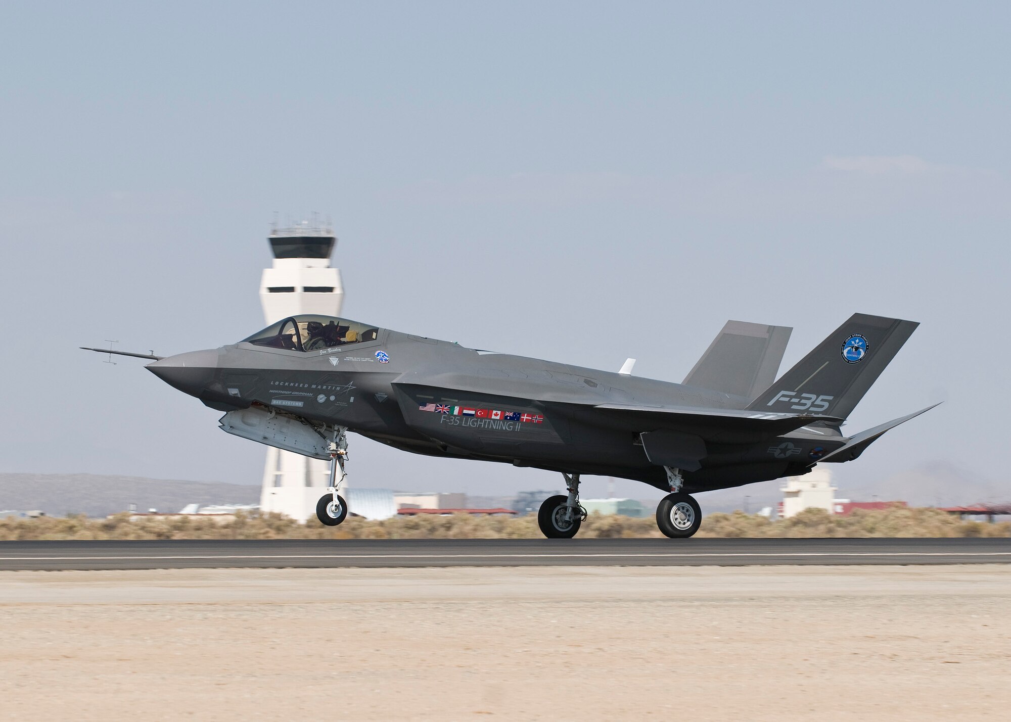 An F-35 Joint Strike Fighter, numbered AA-1, taxis past the Edwards Control Tower Oct. 1 at 1:30 p.m. The flight marks the first time the aircraft arrived here. The F-35 will perform series of tests, including airstart and noise testing.  The aircraft flew in from Naval Air Station Fort Worth, Texas. (Lockheed Martin photo by Andy Wolfe)