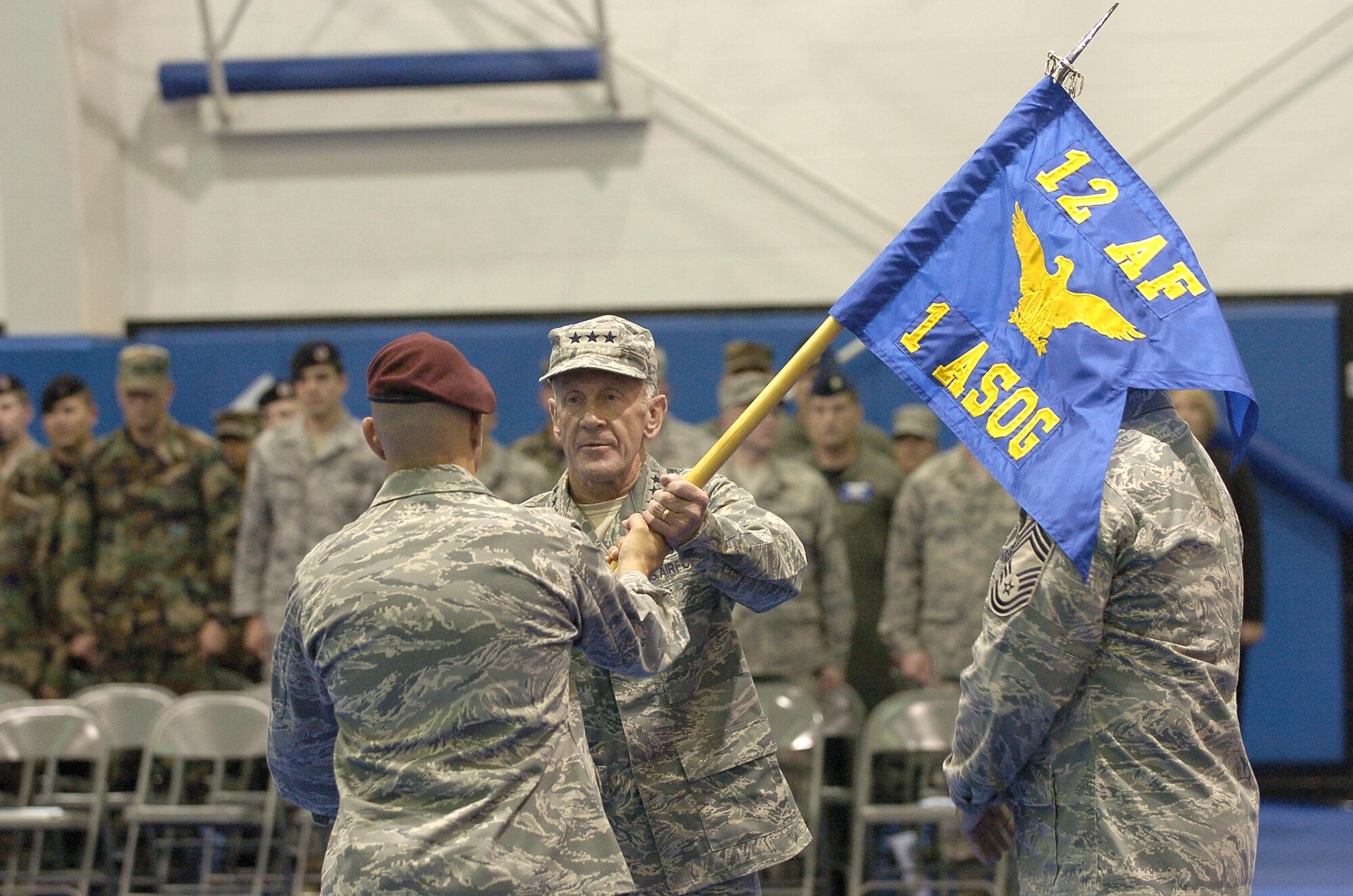 Lt. Gen. Norman Seip, 12th Air Force commander, accepts the 1st Air Support Operations Group guidon from Col. Vincent Savino, 1st ASOG commander, during a redesignation ceremony Oct. 1 at Fort Lewis, Wash. The ceremony transferred the group from Air Combat Command's 12th AF to Pacific Air Forces' 13th AF. (Photo by Phil Sussman)