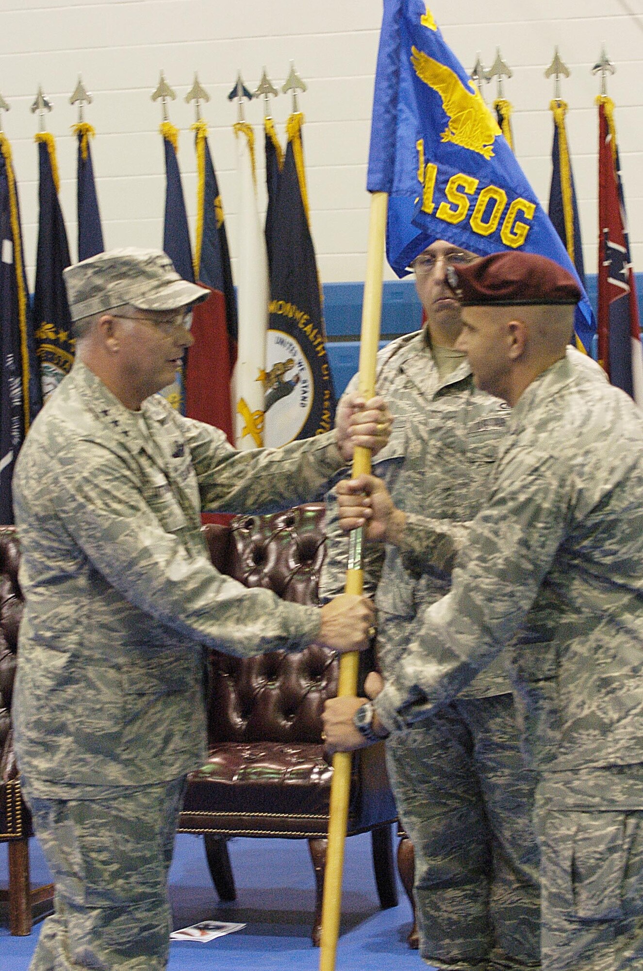 Lt. Gen. Chip Utterback, 13th Air Force commander, presents the 1st Air Support Operations Group guidon to Col. Vincent Savino, 1st ASOG commander, during a redesignation ceremony Oct. 1 at Fort Lewis, Wash. The ceremony transferred the group from Air Combat Command's 12th AF to Pacific Air Forces' 13th AF. (Photo by Phil Sussman)