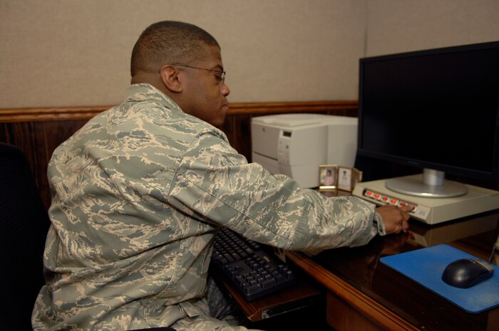 NELLIS AIR FORCE BASE, Nev. -- Lt. Col. Michael L. Dawson, 99th Communications Squadron commander, turns off his computer screen in an effort to conserve energy on base October 1, 2008. The current energy policy for both Nellis and Creech Air Force Bases requires all personnel to turn off non mission-critical computers, monitors and office equipment at the end of each day. (U.S. Air Force Photo by Airman 1st Class Stephanie Rubi)