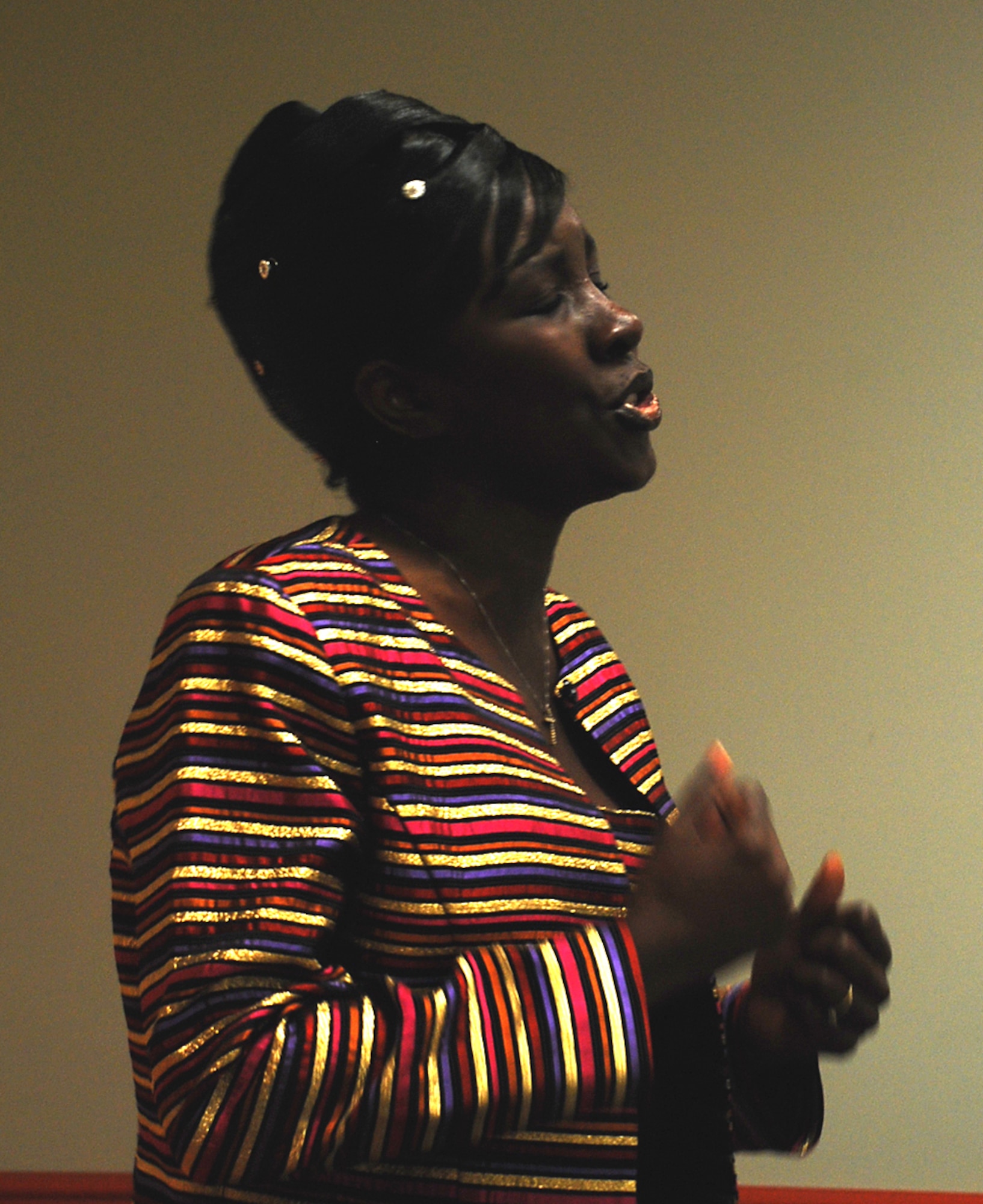 Dorothy Day, an Air Force spouse, sings the song "I'm Here" from the play titled "The Color Purple" during the Domestic Violence Awareness Month proclamation signing ceremony Oct. 1 at the 305th Medical Group clinic. The song is about a woman who is in an abusive relationship but is ultimately victorious. (U.S. Air Force photo/Senior Airman Danielle Johnson)