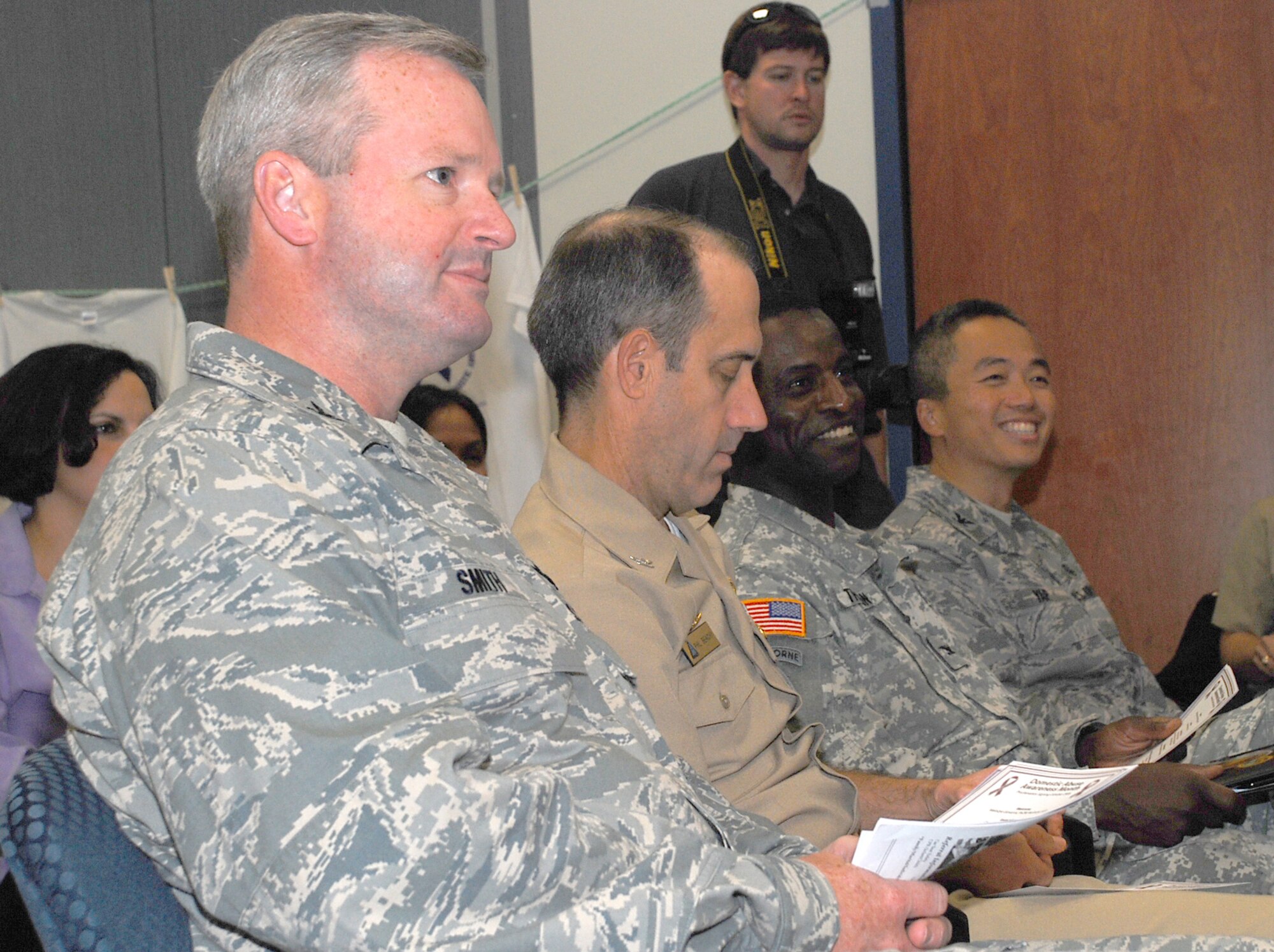 Leaders from the joint base community listen to opening remarks during the Domestic Violence Awareness Month proclamation signing ceremony Oct. 1 at the 305th Medical Group clinic; from left: Col. Scott Smith, 305th Air Mobility Wing vice commander, Capt. Phillip Beachy, Lakehurst commander officer, Col. Ronald Thaxton, Fort Dix installation commander, and Col. Glenn Yap, 305th MDG commander. (U.S. Air Force photo/Senior Airman Danielle Johnson)