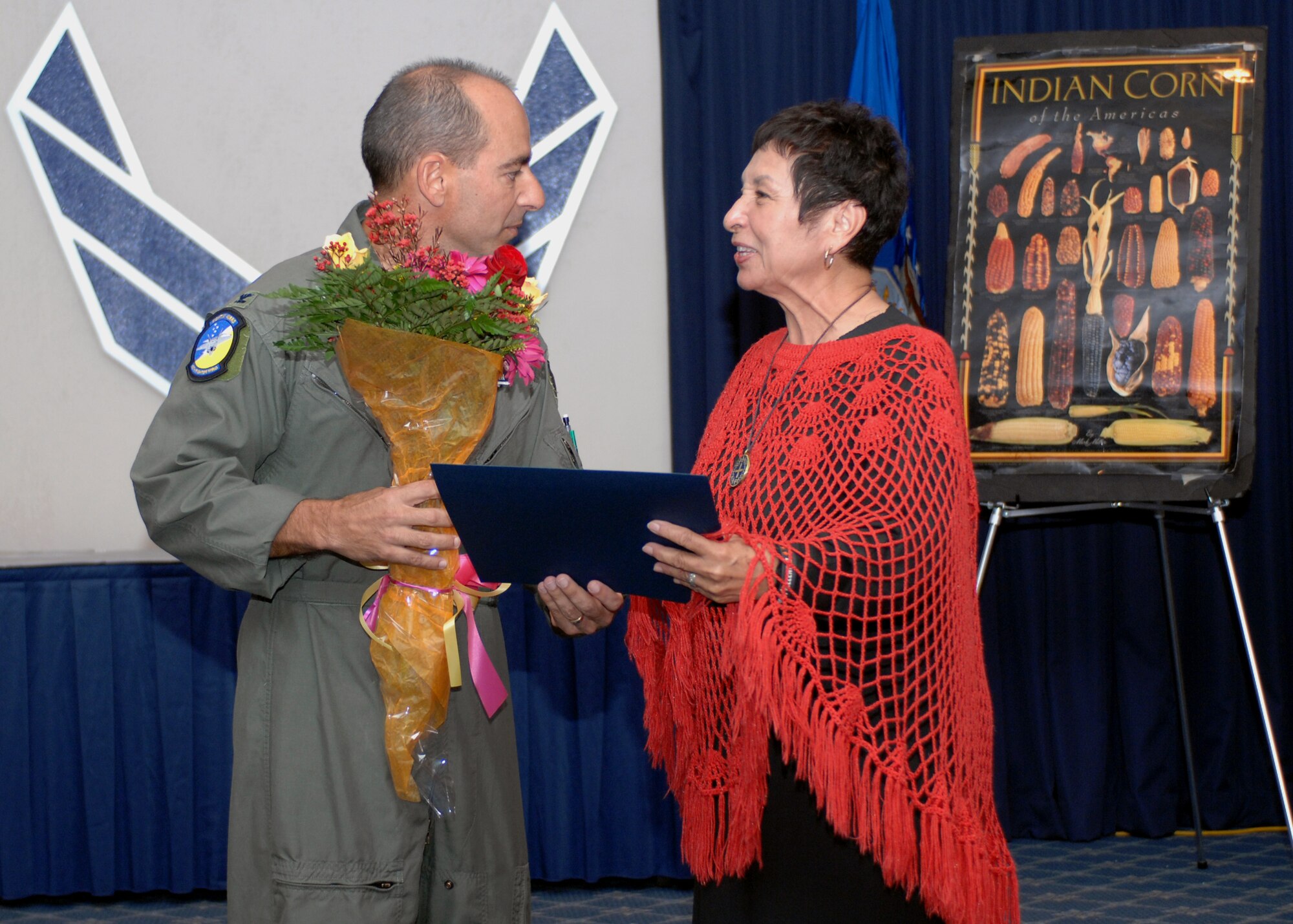 Col. Jeffrey Harrigian, 49th Fighter Wing Commander, hands guest speaker Rosa Guerrero, Texas Woman Hall of Fame, a bouquet of flowers for participating in the Hispanic Heritage celebration. Mrs. Guerrero returns to Holloman Air Force Base, N.M., from from El Paso, Texas to educate all members of Holloman on the customs and traditions of the Hispanic culture.(U.S. Air Force photo/Airman 1st. Class Veronica Salgado)