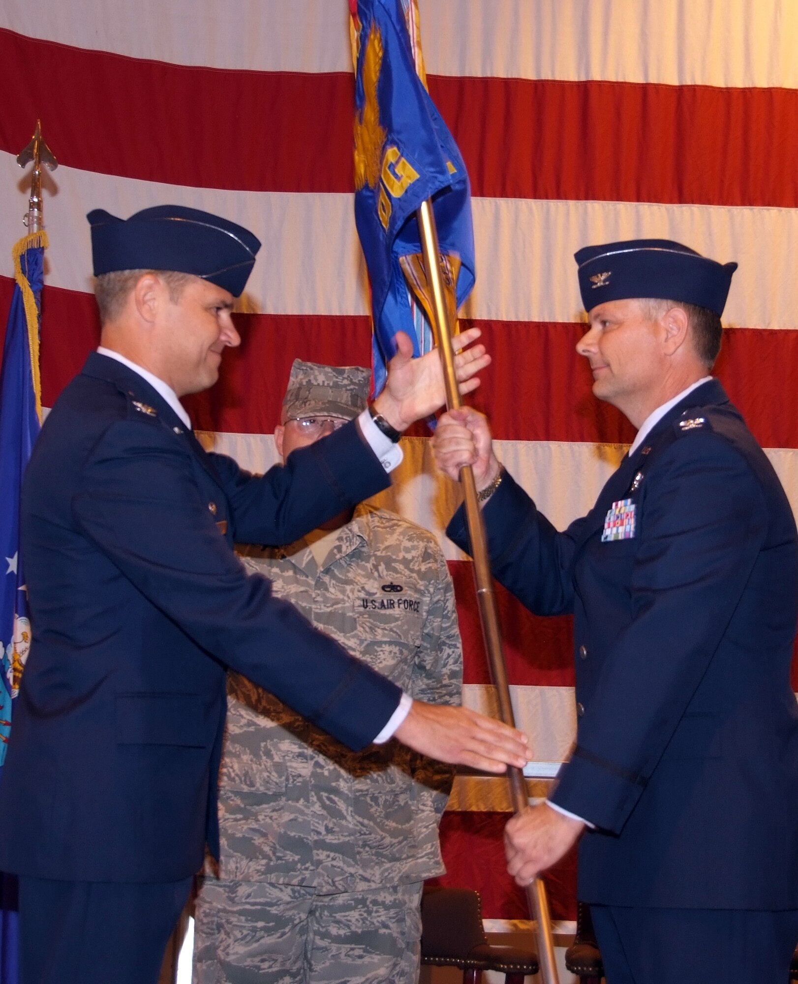 Col. Glen VanHerck, right, accepts command of the 71st Operations Group from Col. Mark Nowland, 71st Flying Training Wing commander, during a ceremony Sept. 19 in Hangar 170. Colonel VanHerck, an F-15 Eagle and B-2 Spirit pilot, comes to Vance from T-6A Texan II pilot instructor training at Randolph AFB, Texas. (U.S. Air Force photo by Terry Wasson)