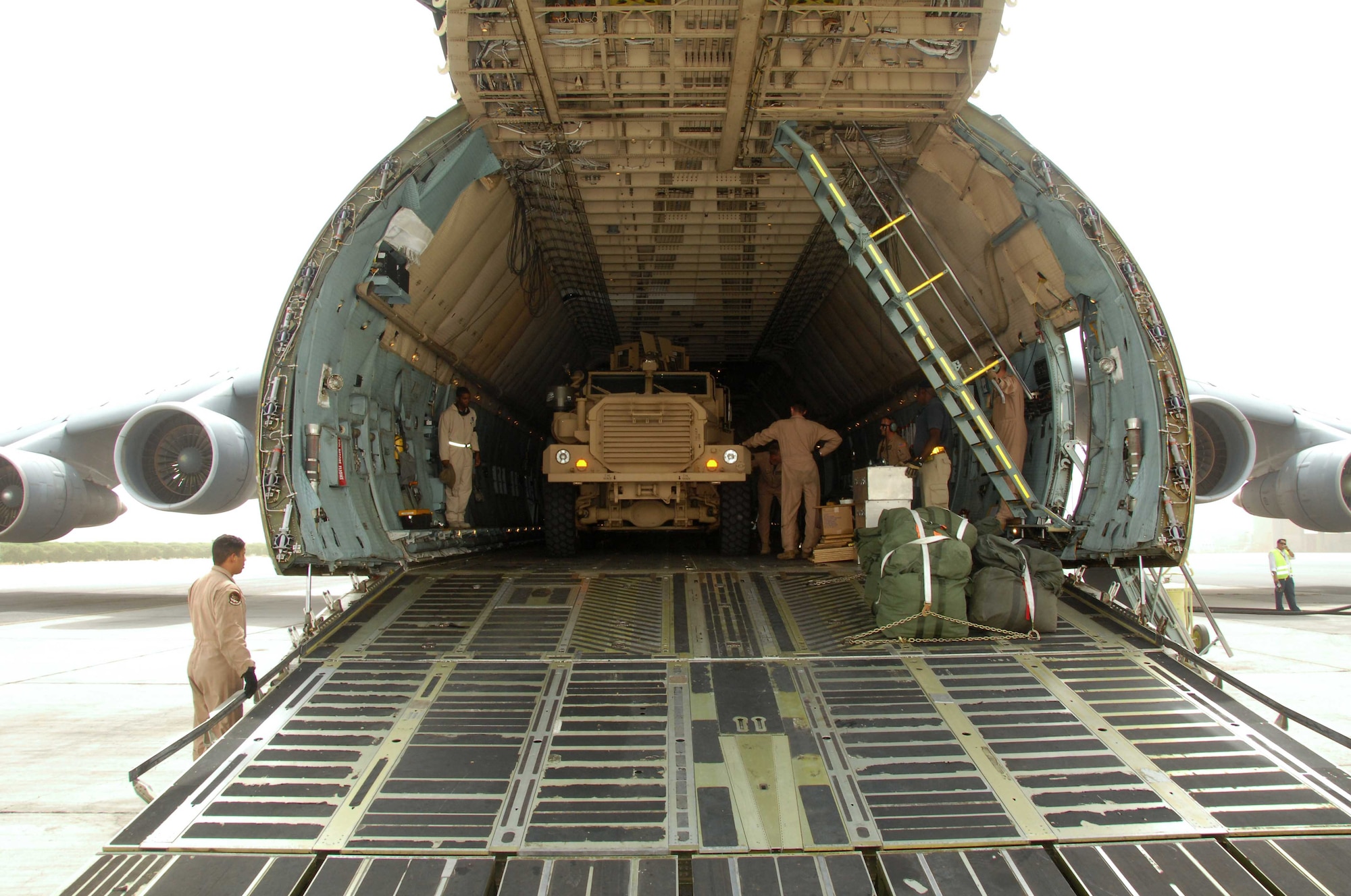 A crew of Team Travis members prepare to unload the 10,000th mine-resistant, ambush-protected vehicle in Southwest Asia recently. Since the MRAPs introduction in 2007, Air Mobility Command Airmen have worked continuously to deliver the vehicles to troops supporting Operations Iraqi and Enduring Freedom. (U.S. Air Force photo)